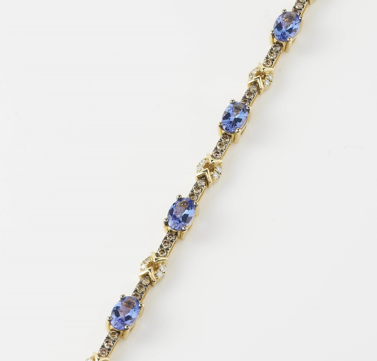 Le Vian Diamond & Tanzanite Tennis Bracelet: Tennis bracelet with (9) oval cut tanzanite measuring 6.07 x 3.98 x 2.96 mm, (54) total round Le Vian diamonds measuring 1.77 mm in diameter, and (36) round diamonds measuring ~1.48 mm in diameter. al