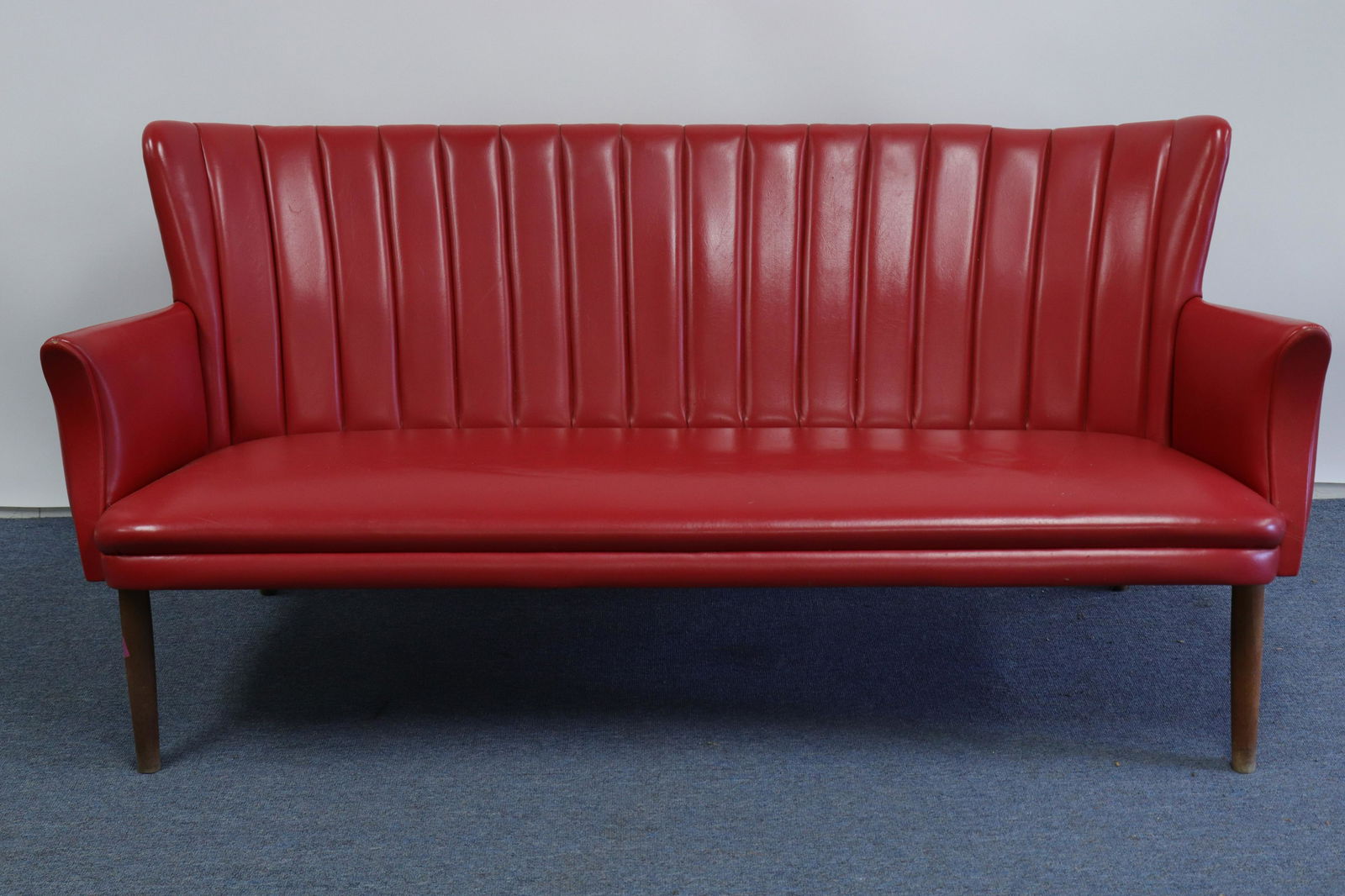 Danish Modern Sofa Svend Skipper c.1950: Danish Mid Century Modern Sofa by Svend Skipper, red vinyl upholstered Dimensions: 30.25 H x 63.5W x 28.5D Property from a Litchfield home (SHEL9408)(MM)