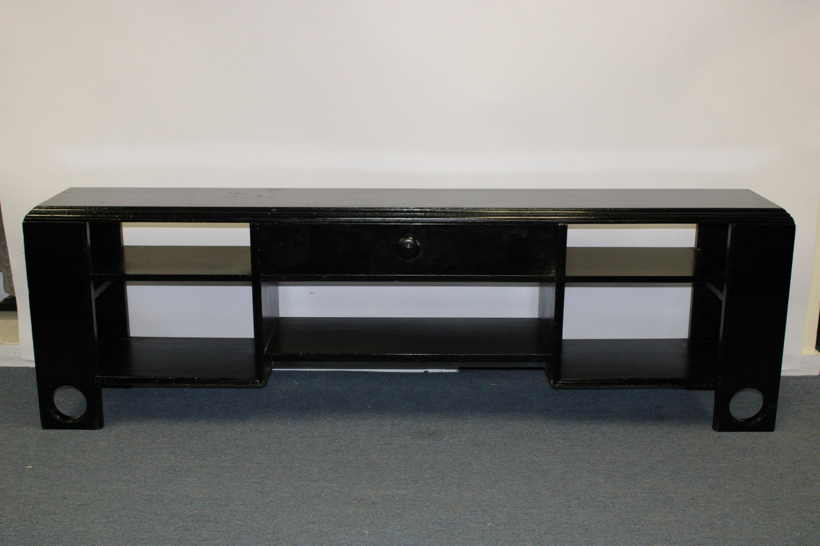 James Mont Black Lacquer Dwarf Bookshelf, c 1960: James Mont Black Lacquer Dwarf Bookshelf, circa 1960, branded James Mont Design Dimensions: 27 1/2" H x 87" W x 14 1/2" D Property from a South Kent, CT collector. (JOHN676)(MS)