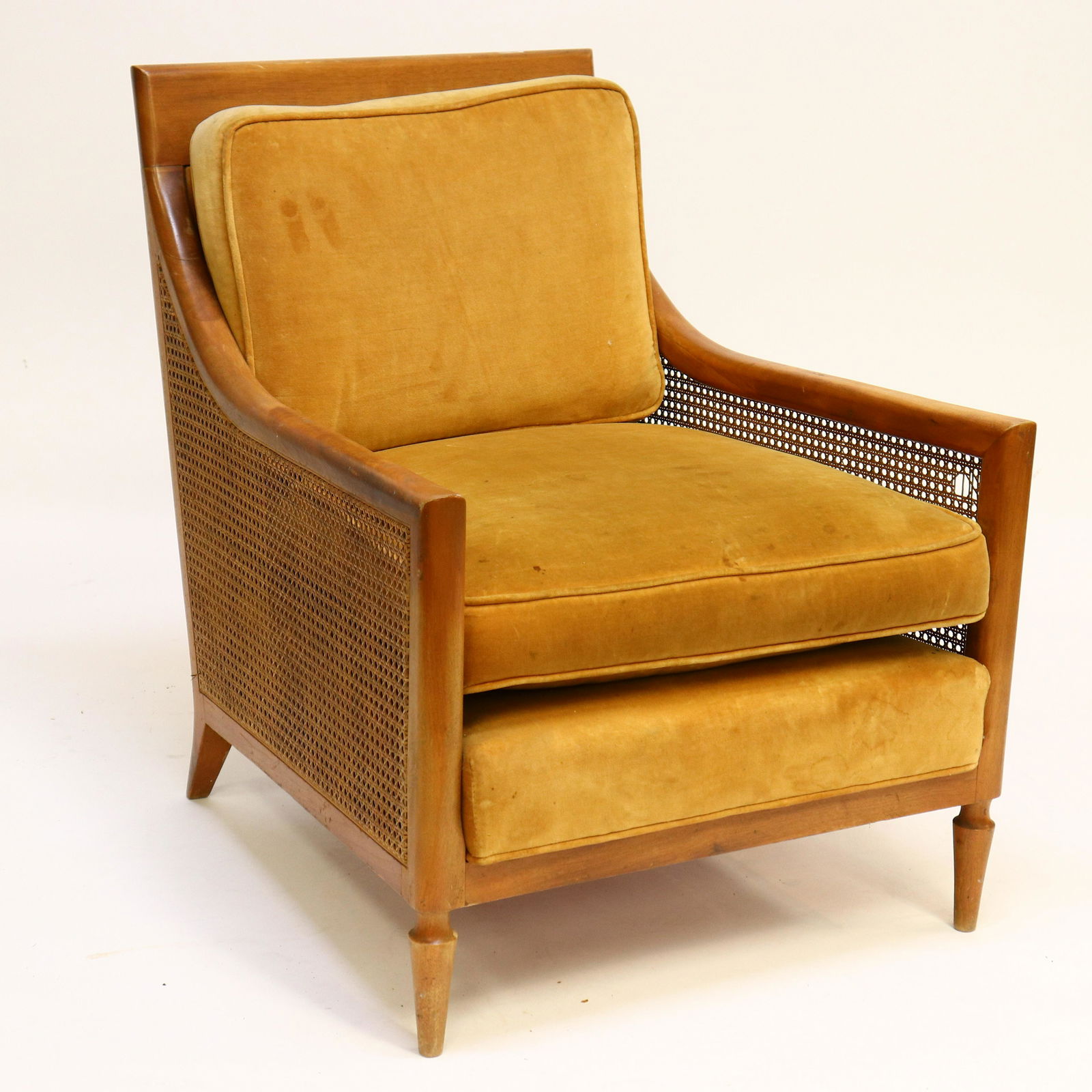 T.H. Robsjohn-Gibbings Caned Side Armchair: By or attributed to. Wood framed, caned sides, gold velvet cushioned back and seat. Not marked and/or labeling removed. Structurally sound, solid. Dimensions: 32"H x 34D overall x 26.75W seat 17.5H. 2