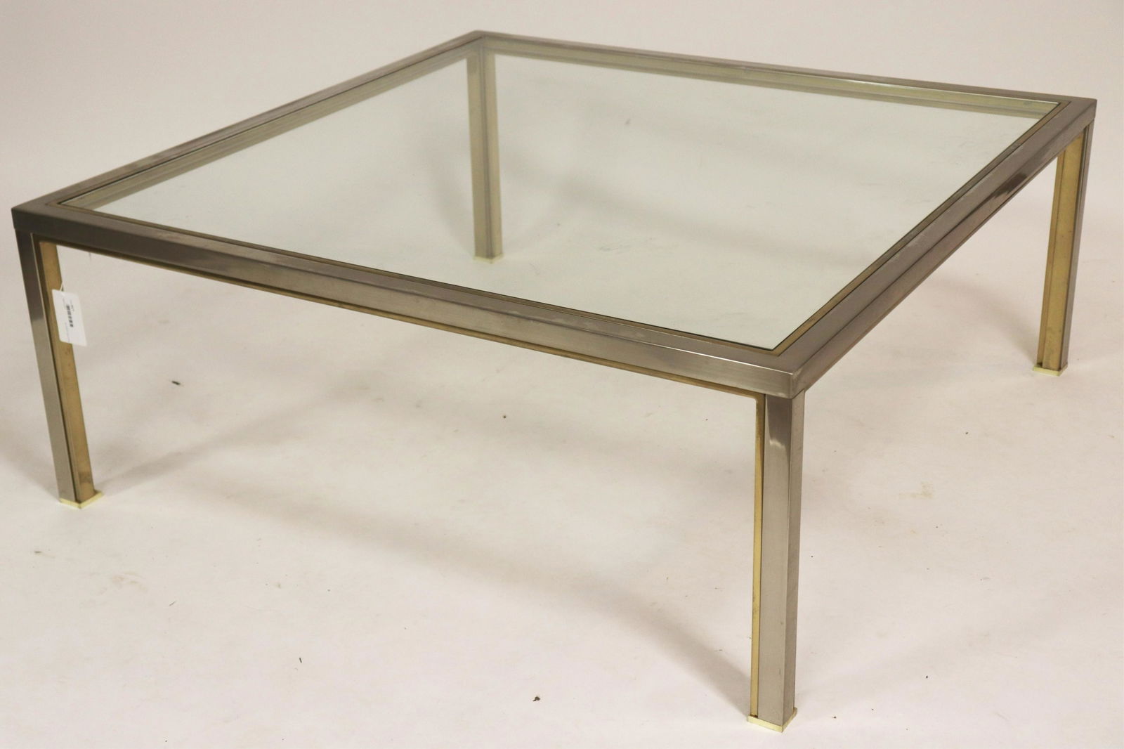 Steel and Glass Modern Coffee Table: Steel and Brushed Brass Finish Modern Cocktail Table Inset Glass, feet ended out with brass cap Dimensions: 43" Square x 17"H Property from a Litchfield County home (SDAY2517)(MM)