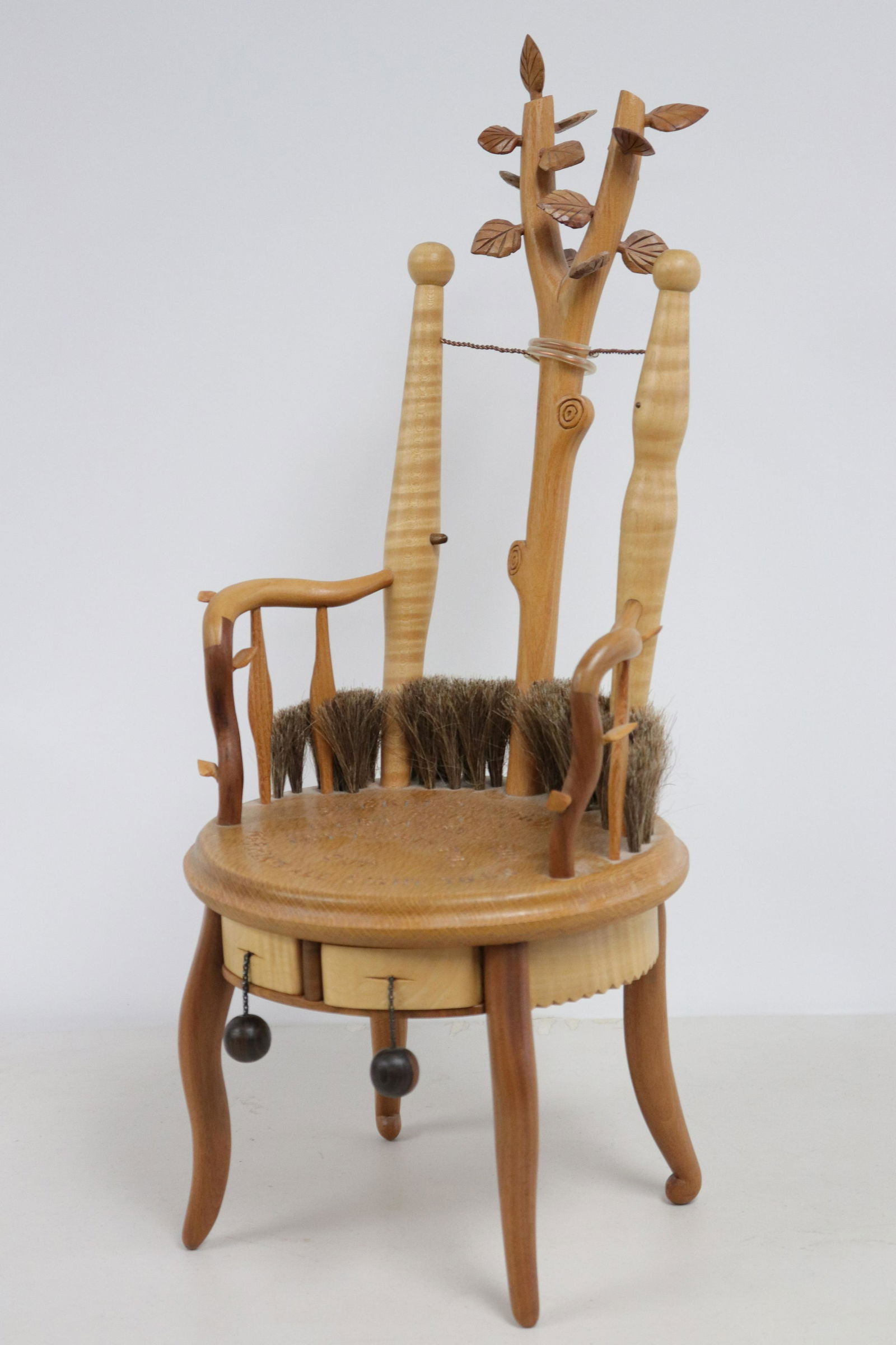 Tommy Simpson Child's Branch & Leaf Theme Armchair: L20C. Mixed woods. Vertical "branch" splat. Circular seat with moulded edge,inscribe carved inscriptions, notched seat apron, broom/brush bristle along back. Carved leaf decoration. Two fitted drawers