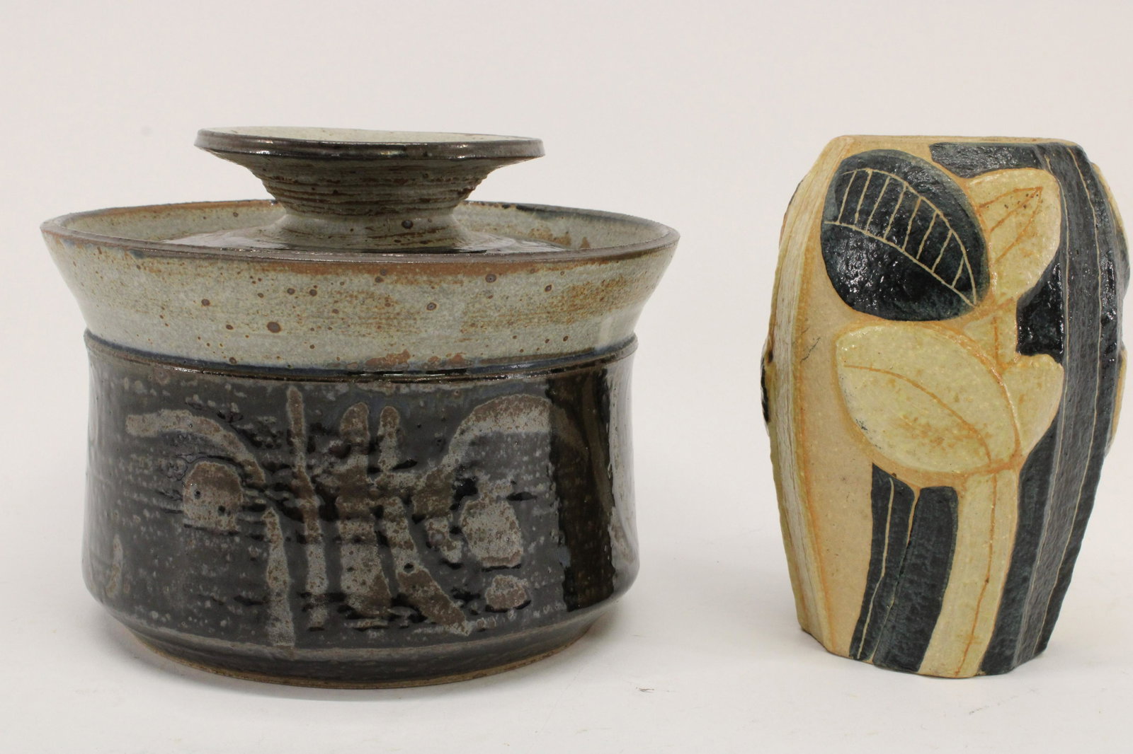 2 Stoneware Items; Gerry Williams, Backhauser: Gerry Williams Stoneware Lidded Jar, signed & Noomi Backhauser Stoneware vase for Soholm Denmark, plant forms in relief, signed Dimensions: 6 1/4" H x 7 1/2" dia. & 6 1/4" H x 4" dia. Property from th