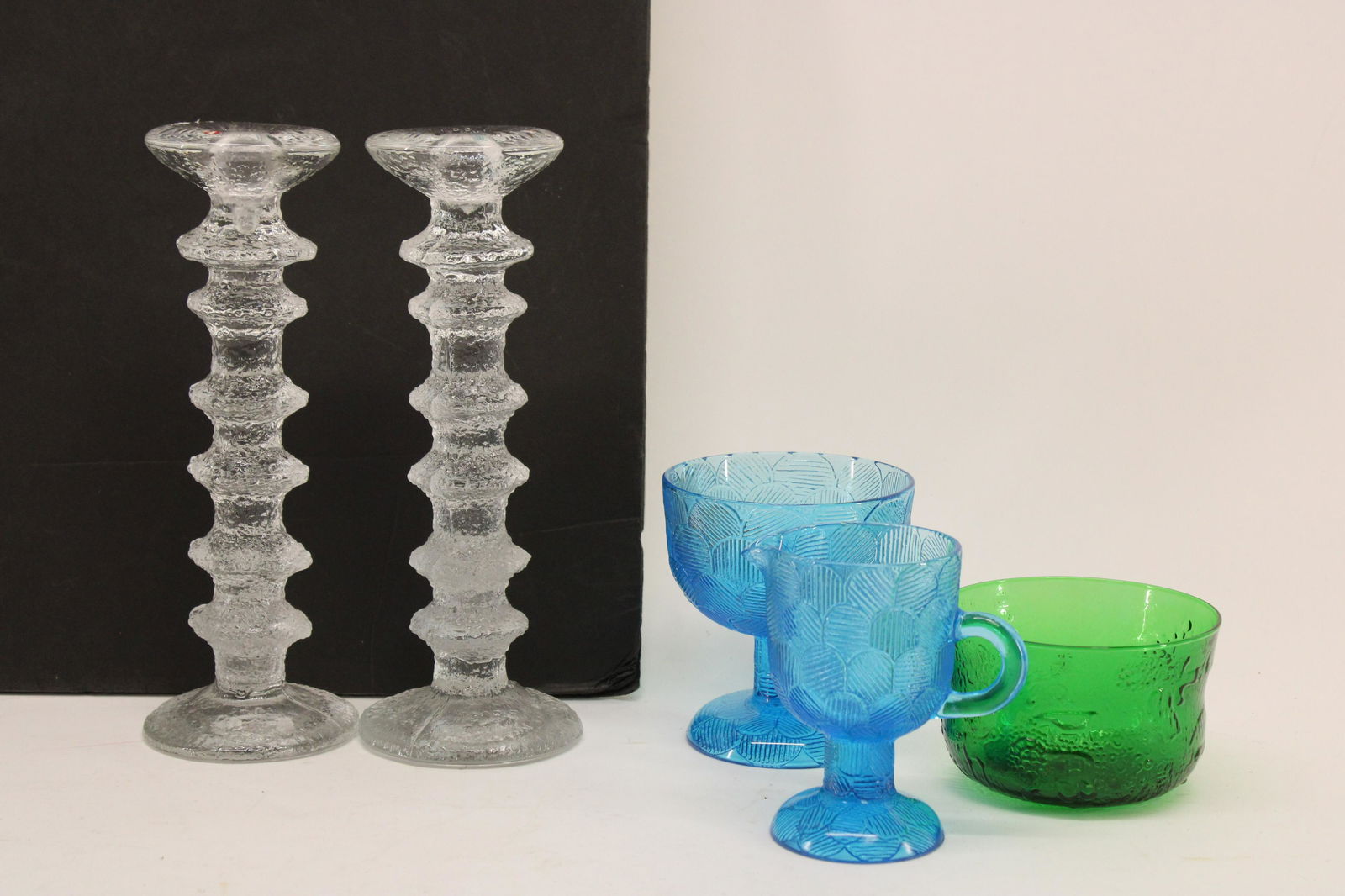 5 Pc. Pressed Glass by Iittala, Finland: 5 Pieces Pressed Glass by Iittala, Finland; pair clear candlesticks by Timo Sarpaneva, green bowl by Oiva Toikka and blue creamer and sugar by Heikki Orvola Dimensions: Sticks 9 1/2" H, green 2 3/4" H