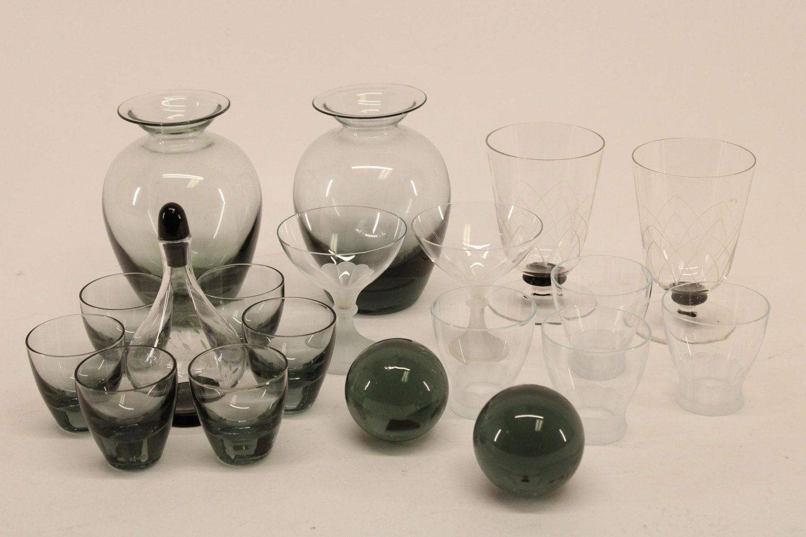 17 Small Glasses & Decanters; Copier, Orrefors: 17 Small Glasses & Decanters, 8 Smokey by A.D. Copier, Leerdam Netherlands from the Rondo series and 9 clear/etched or frosted by Orrefors Dimensions: Decanters with ball stoppers 7 1/2" H, small fros