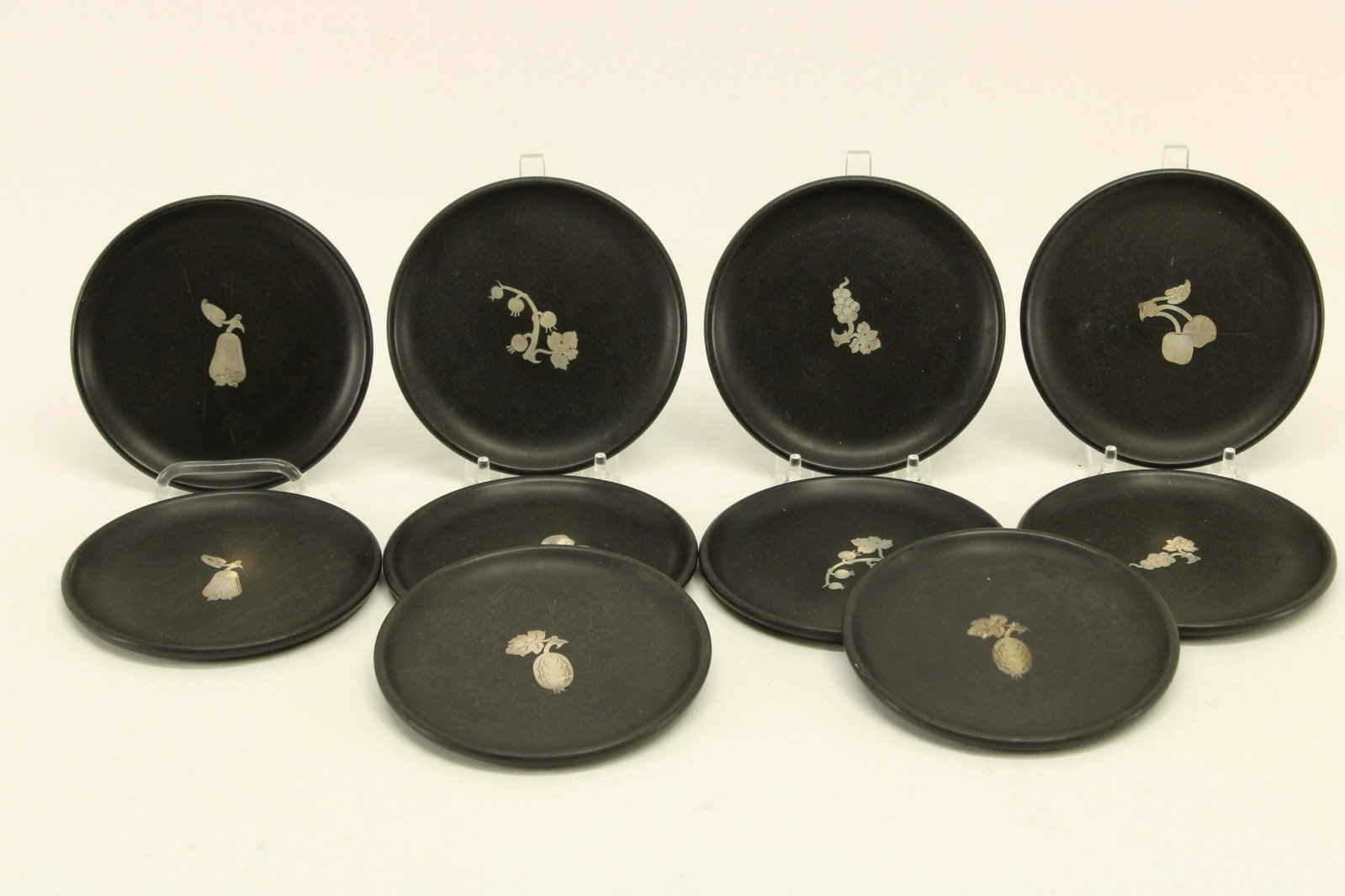Perstorp Sweden, Bakelite & Sterling Fruit Plates: T. Wendt for Perstorp Sweden, set of 10 Bakelite & Sterling Fruit Plates. Inlaid design. Stamp signed on bottom. Dimensions: 5.75" diam Property from a South Kent, CT collector. (JOHN7)(JP)