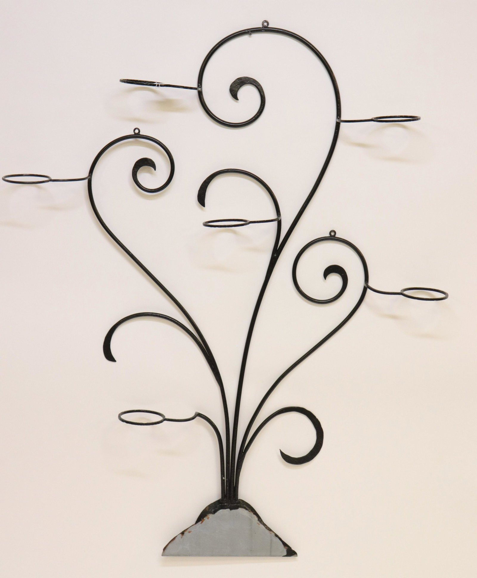 Metal Wall Mount Plant Holder & Sconces: Black Painted Metal Wall Mount Plant Holder and Pair of Similar Sconces, wired Dimensions: 56" H x 45" W and 11" H x 9 1/2" W Property from the Litchfield Estate of Tracy H. Griswold (TGLI8389/3)(WT)