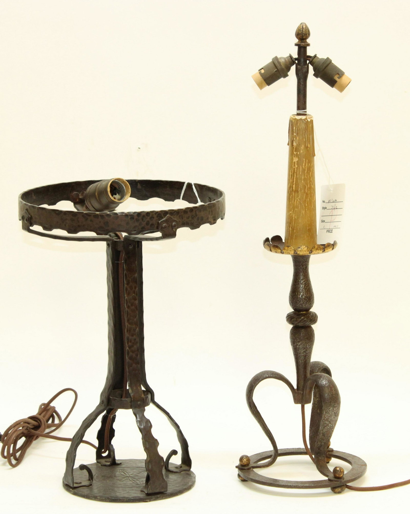 2 Arts & Crafts Wrought Iron Lamps: 2 Arts & Crafts Wrought Iron Lamps, 1 missing shade Dimensions: The larger to the finial 21 3/4" Property from the Estate of an Important New York Modernism Dealer. (NJWA31/2)(MS)