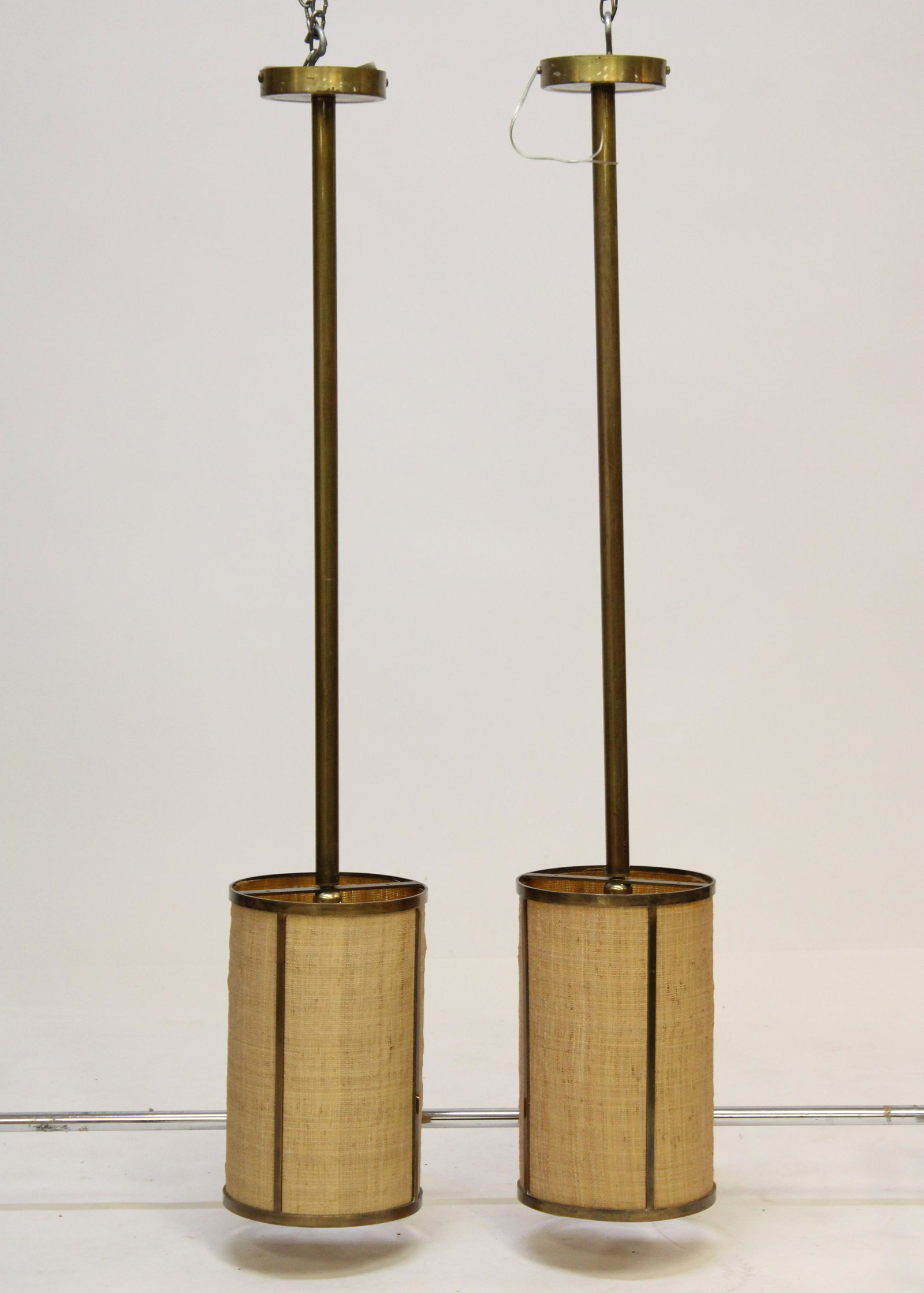 Pair Mid Century Brass & Linen Ceiling Fixtures: Pair Mid Century Brass & Linen Ceiling Fixtures Dimensions: 56" H Property from the Estate of an Important New York Modernism Dealer. (NJWA440/2)(MS)