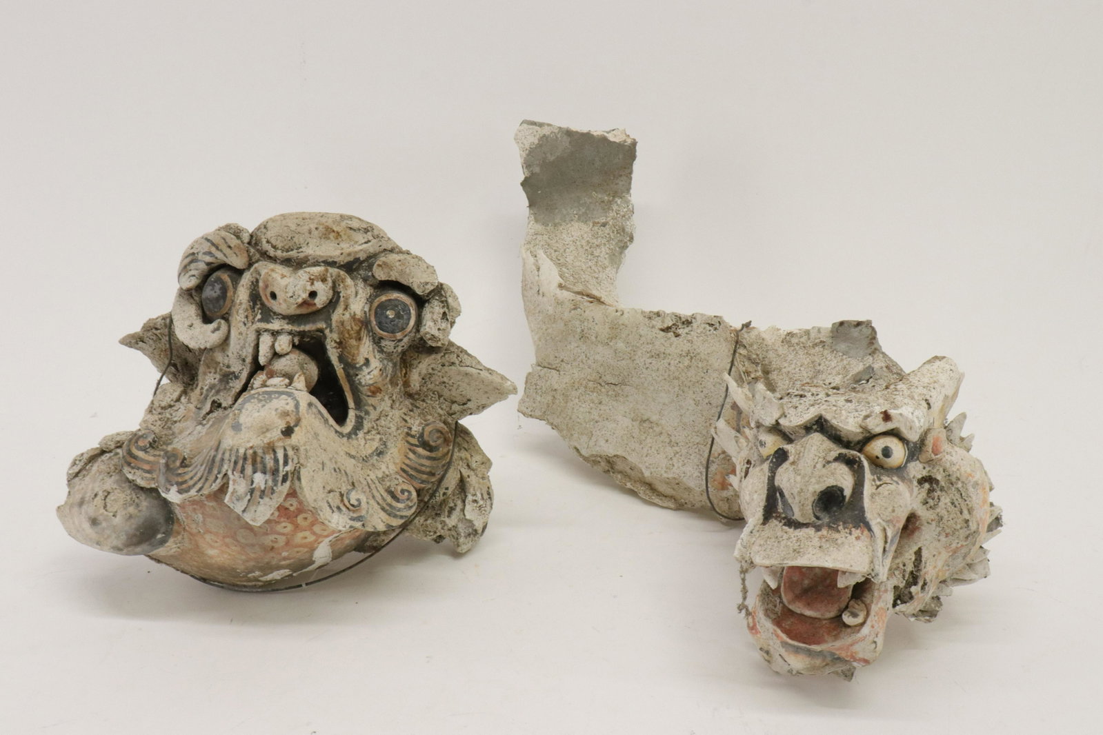 Two Cast & Painted Building Ornaments (Singapore): Multiple media- brick/tile, cement, lime/plaster, remnants of paint. From a building facade. One as dragon-serpentine shape. As is. Dimensions: 18.75"L x 7.5H and 8 x 8 x 6 Property from a Northwest C