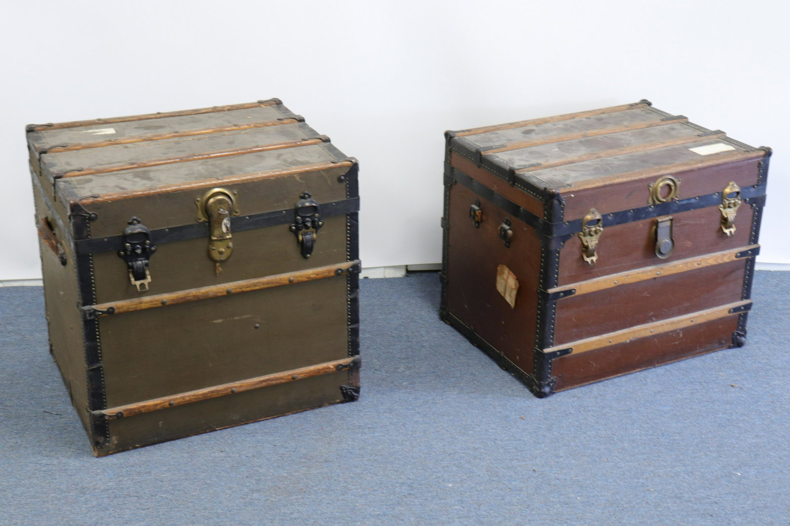 Two "Near Square" Travel Trunks Henry Likely & Co.: Henry Likely & Co., Rochester NY. One with paper label inside, metal manufacturing badge outside; one no labels but both with same construction. Standing wood ribs, fabric lined, leather side handles,