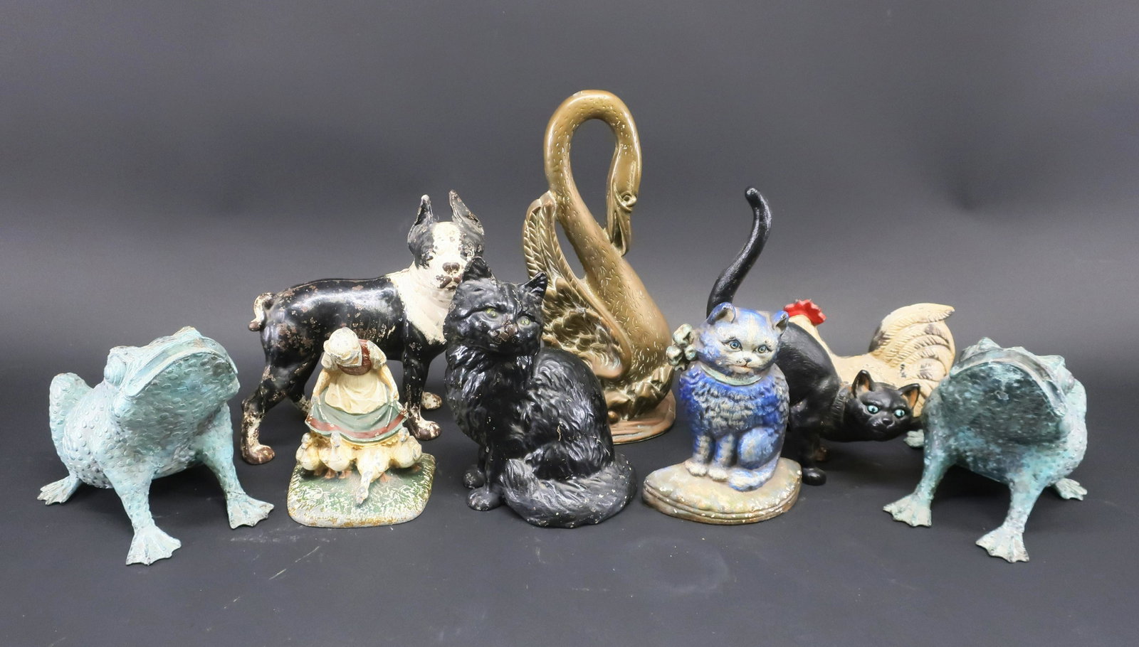 9 Vintage Door Stops: 9 Vintage Door Stops, includes 6 painted cast iron, 1 brass and 2 patinated brass frogs Dimensions: Hen 6" H x 8 1/2" L, Brass Phoenix 13 1/2" H X 5 1/2" W Property from the Estate of C. Carter Walker