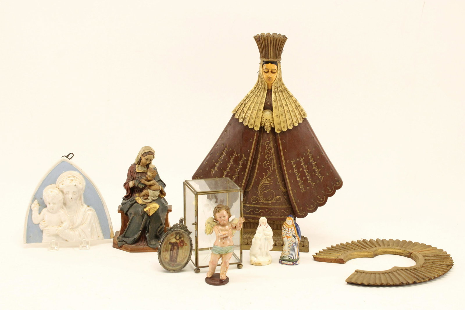 Group of Madonna & Child and Other Items: Group of Madonna & Child Representations and other items, comprises: 3 carved & polychromed wood figures, a wax or soapstone locket and 3 in porcelain/faience, one in Quimper Dimensions: Largest 18" H