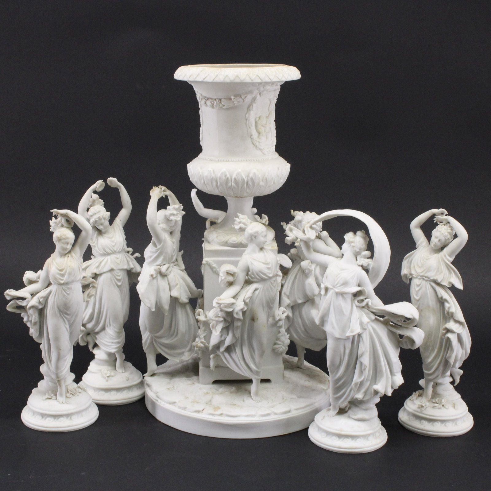 5-Piece German Bisque Figural Centerpiece Group: 5-Piece German Bisque Figural Centerpiece Group, urn and dancing maidens Dimensions: Urn 15" H x 8" Dia., Maidens 10" H Property from the Litchfield Estate of Tracy H. Griswold (TGLI8075/5)(WT)