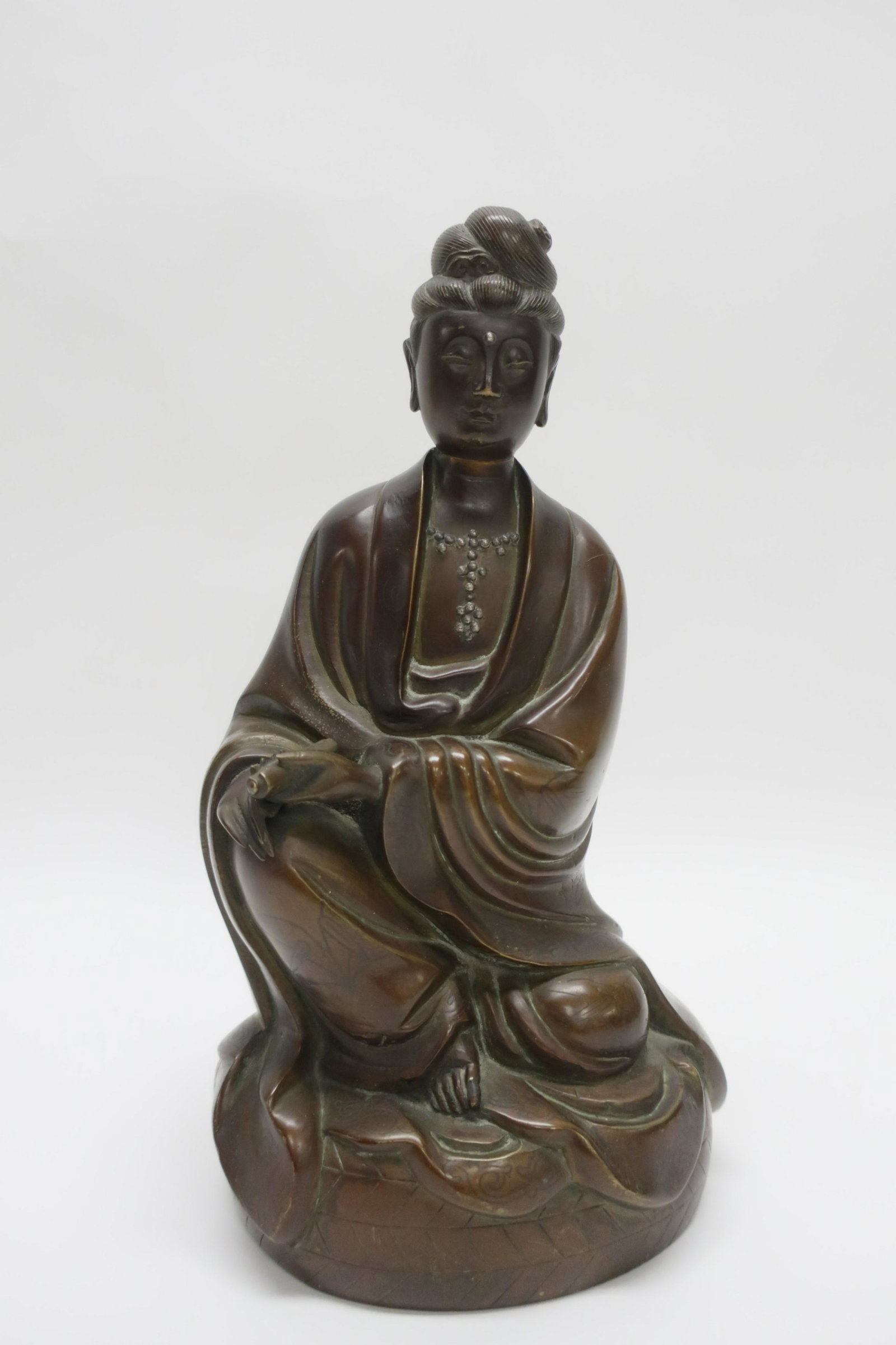 Chinese Bronze Seated Guanyin: Nicely cast, 19th/20th century with silver inlay detail and a Shisou inlay mark on the back. Dimensions: 10 1/2" high Property from a Connecticut shoreline collector (DACHA865)(PR)