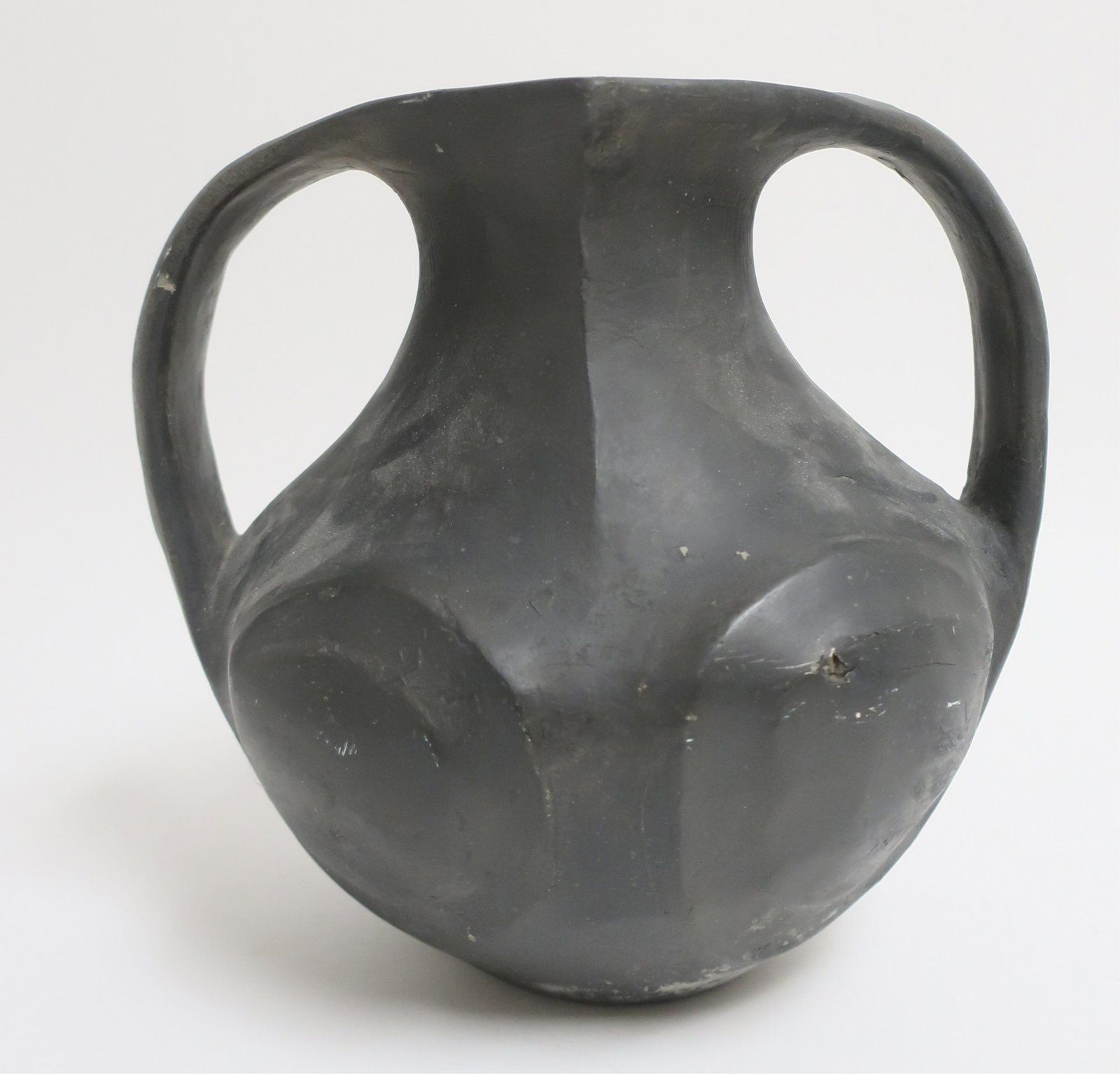 Chinese Han Lifan Swirling Eye Vessel: Very beautifully formed and burnished blackware pottery vessel in the unusual style of this region and period. The graceful shapes may refer back to the Neolithic shapes and styles. Each side mirrors 