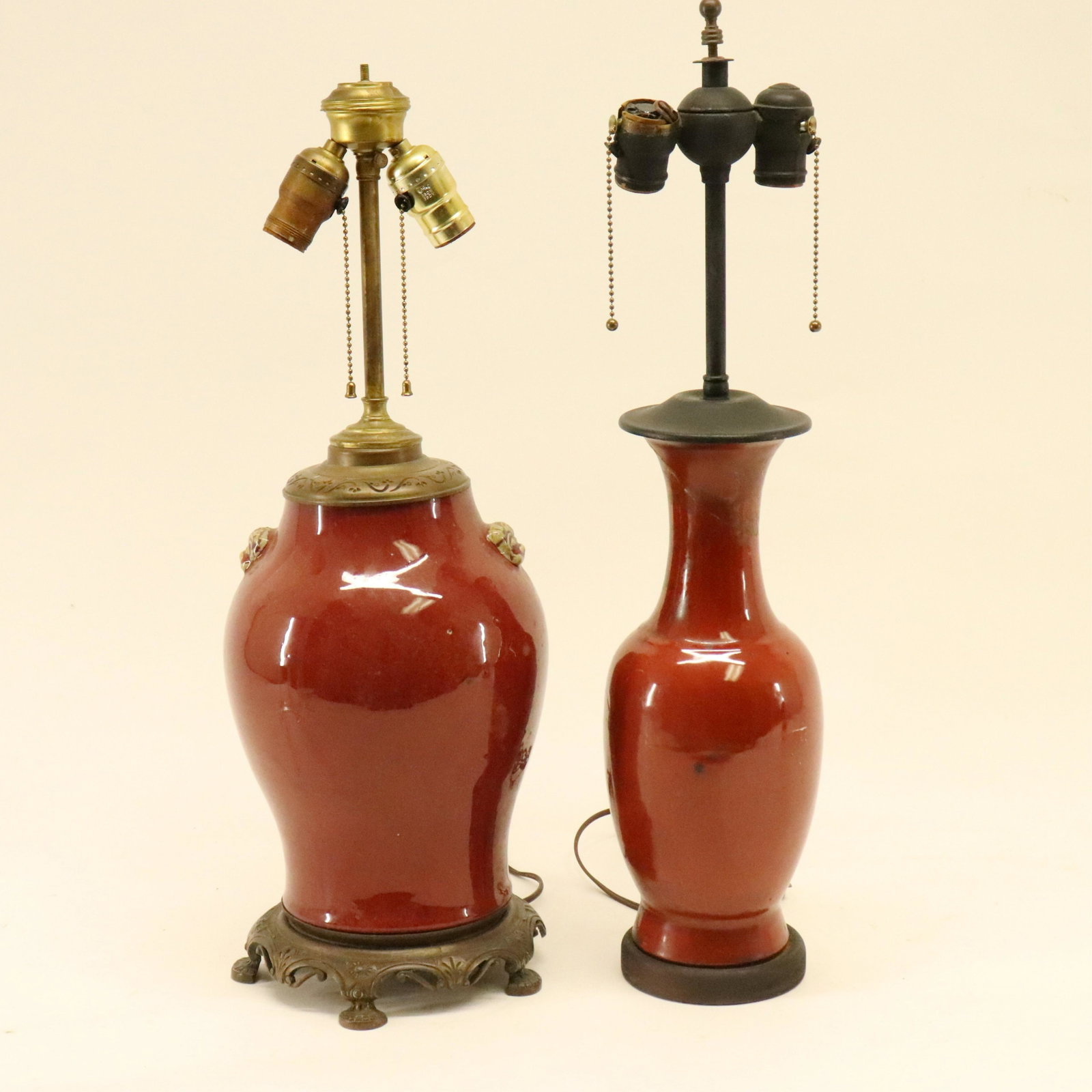 2 Chinese Porcelain Sang de Boeuf Lamps: 2 Chinese Porcelain Sang de Boeuf Lamps, foo lion mark handles to one Dimensions: Mask 11 1/4" x 7" Dia. Property from the Litchfield Estate of Tracy Griswold (TGLI9181/2)(WT)