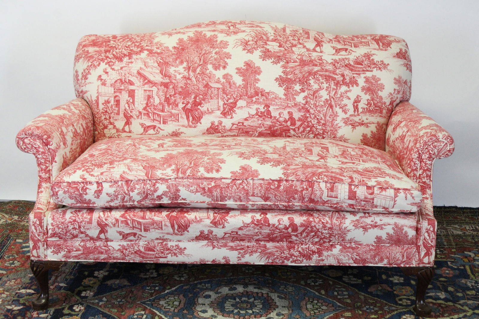Queen Anne Style Upholstered Loveseat: Queen Anne Style Upholstered Loveseat, semi down fill, upholstered in red and white cotton Dimensions: 33" H x 56 1/2" W x 36" D Property from the Estate of Jack Richmond being auctioned to benefit Pr