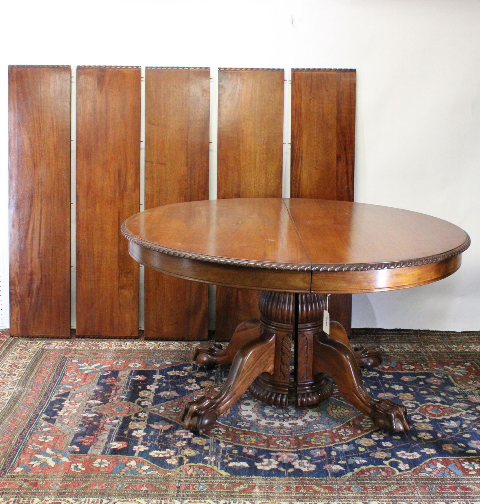 19C Amer. Mahogany Dining Table Paw & Ball Feet: Dramatic scale paw and ball feet. Round top in two halves without leaves. (5) additional rectangular leaves. Base pedestal is constructed in two interlocking halves. Gadrooned top edge. Metal slide as