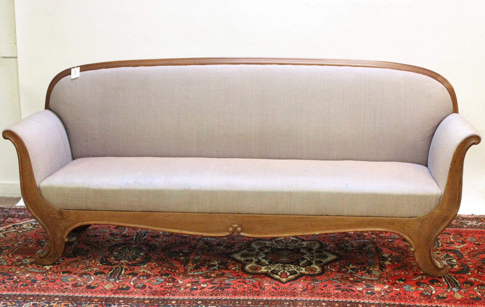 Walnut Frame and Upholstered Provincial Sofa: Long, linear shape. Continuous scrolled arm to foot frame. Dimensions: 82.5"L x 36H. 25 overall depth 19 seat to back depth Property from a Litchfield home (CHOO1218)(JP)