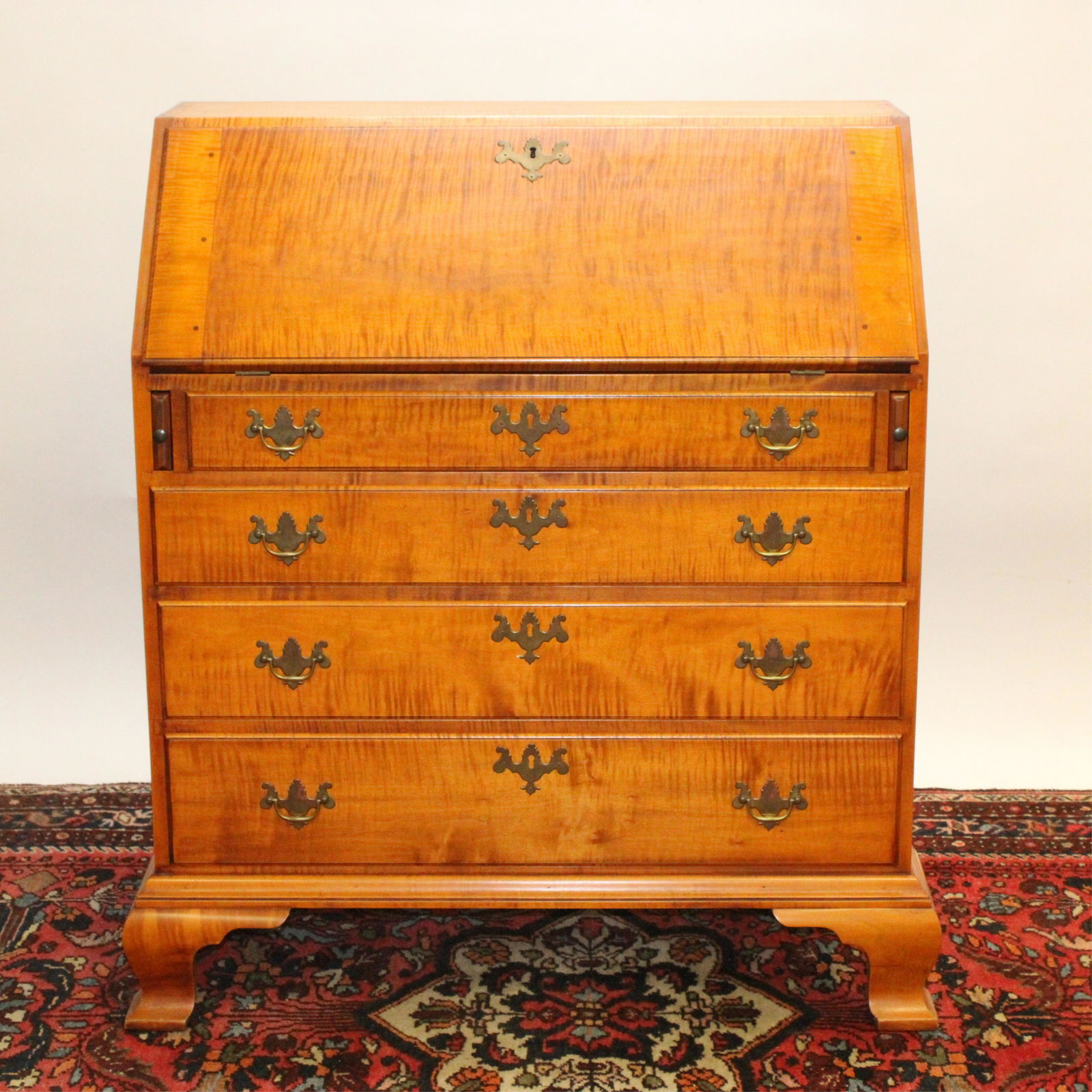 Eldred Wheeler Tiger Maple Slant Front Desk: Eldred Wheeler Tiger Maple Slant Front Desk, reproduction of a northern Connecticut Slant-Lid Deskcirca 1760-1780, fitted with a fan-carved, stepped and serpentine interior, drawer interior marked Dim