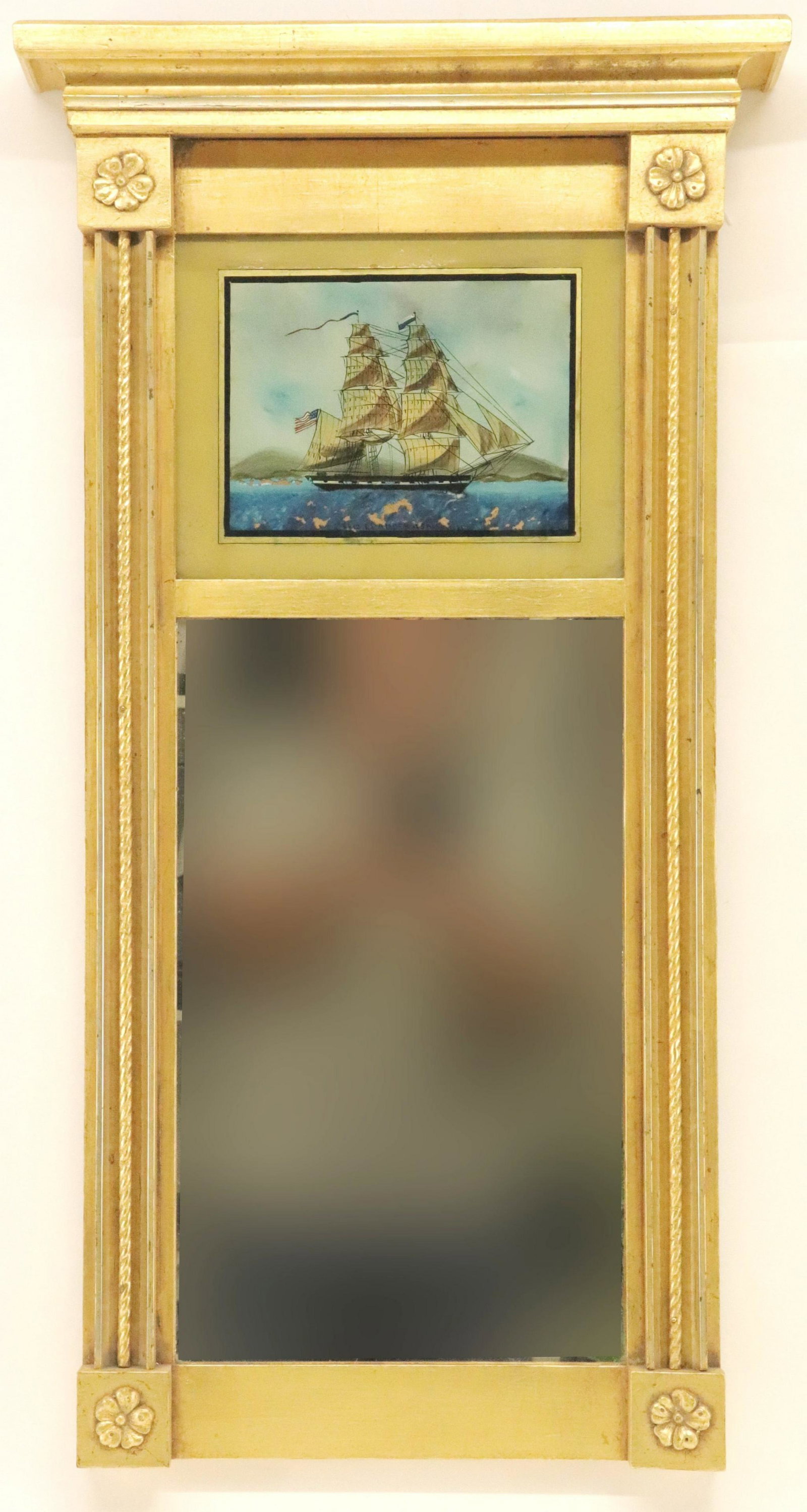 19th - 20th C. Ship Eglomise Mirror: L. 19th-E. 20th C. Gilt Carved Eglomise Mirror, flanking columnar sides and floral rosette Dimensions: 30 1/2 x 17 1/2 x 3 Property from a Woodbury, CT home (MZIL182)(MM)