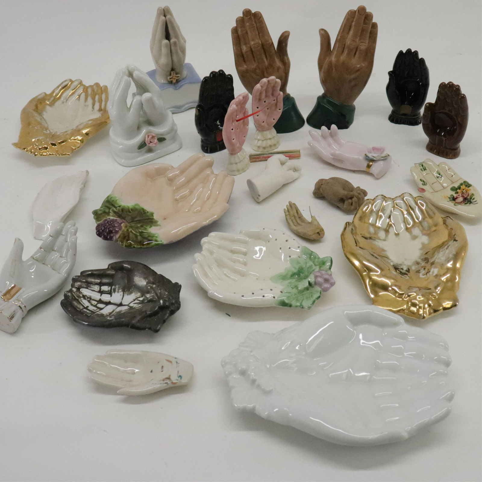 23 Ceramic Hands: 23 Ceramic Hands, includes toothpick holder dishes, ash trays, hand dishes and more Dimensions: 2 1/2" to 8" Property from the Litchfield Estate of Tracy Griswold (TGLI9191/23)(WT)