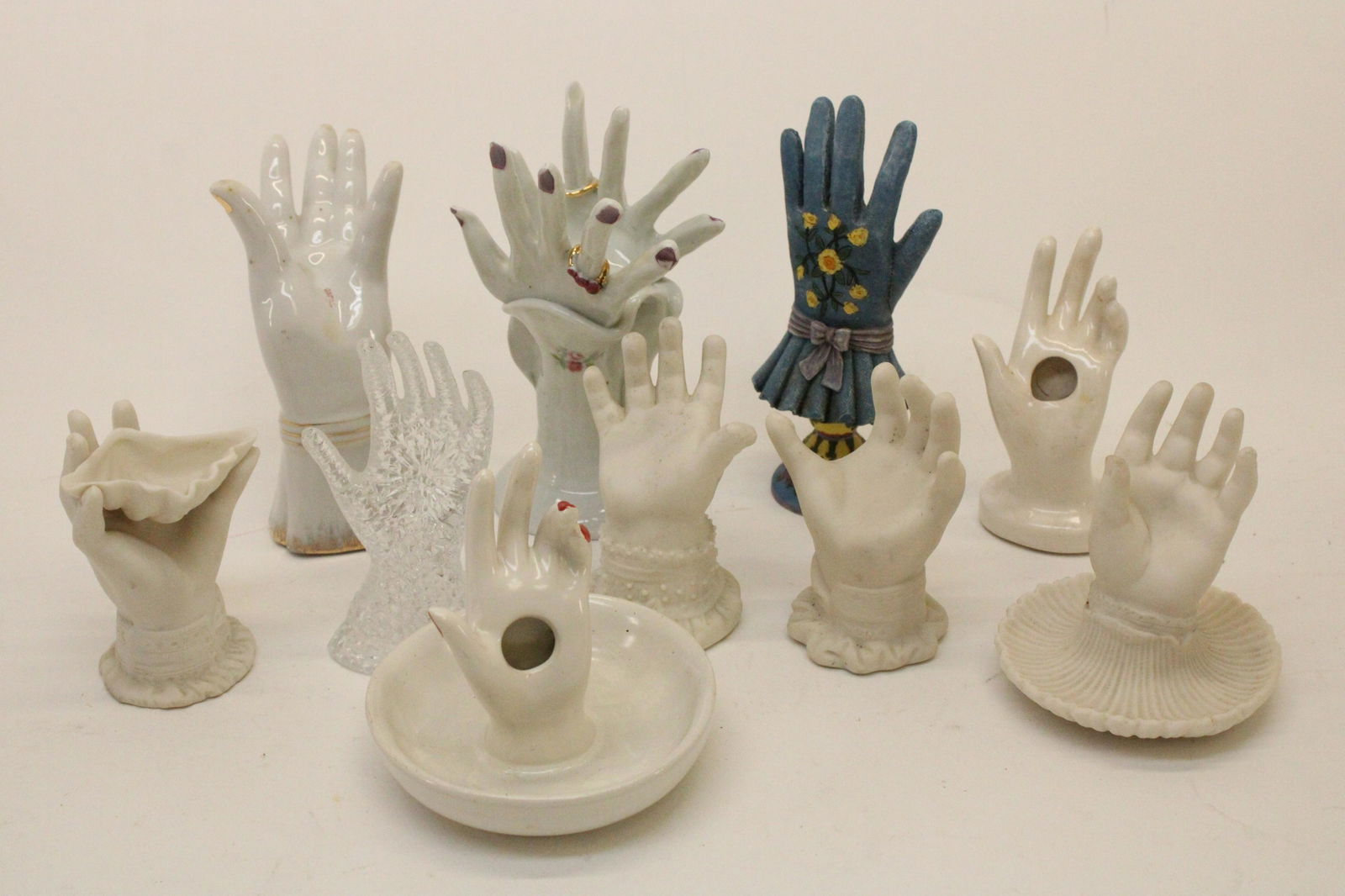 10 Ring Holder Hands: 10 Ring Holder Hands, in porcelain, glass, composition and bisque Dimensions: 5" H x 12 1/2" L Property from the Litchfield Estate of Tracy Griswold (TGLI9190/10)(WT)
