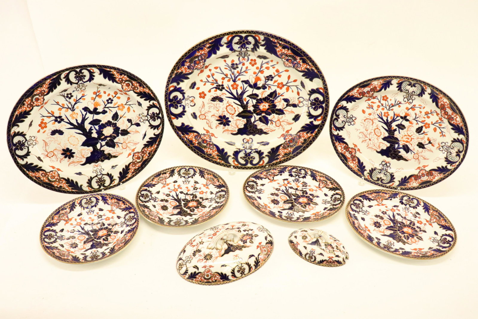 9 Derby Porcelain Imari Table Wares, Late 19th C.: 9 Derby Porcelain Table Wares, red mark, Late 19th C., Imari pattern Dimensions: Largest platter 18 1/2" L smallest cover 6 1/2" L, dinner plates 10 1/4" dia. Property from the Estate of Sara E. Vagli