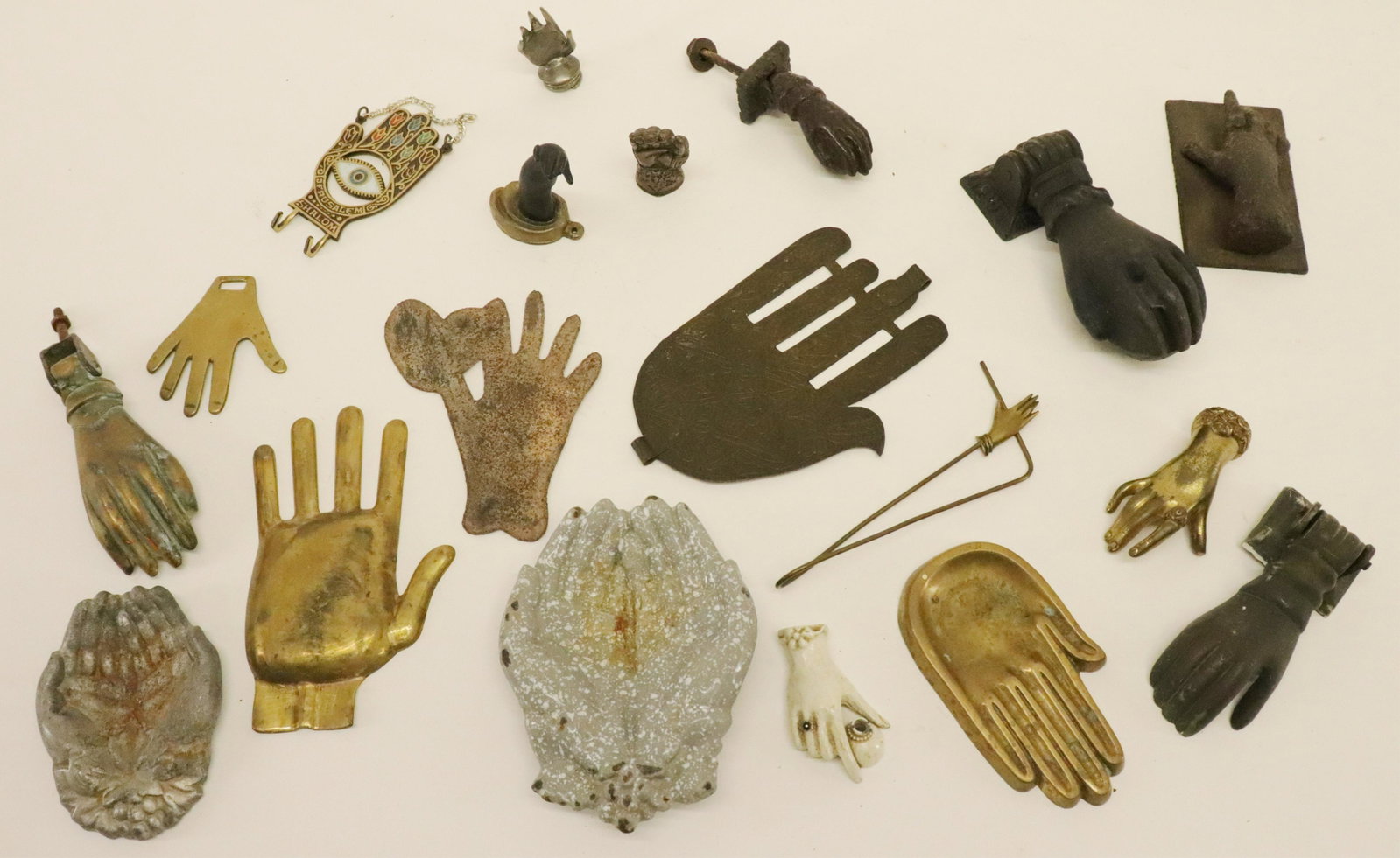 Group Bronze, Brass & Metal Hands: Group Bronze, Brass & Metal Hands, as door knockers, ash trays and more Dimensions: Smallest 2 3/4" to Largest 8 1/2" Property from the Litchfield Estate of Tracy Griswold (TGLI9194/lot)(WT)