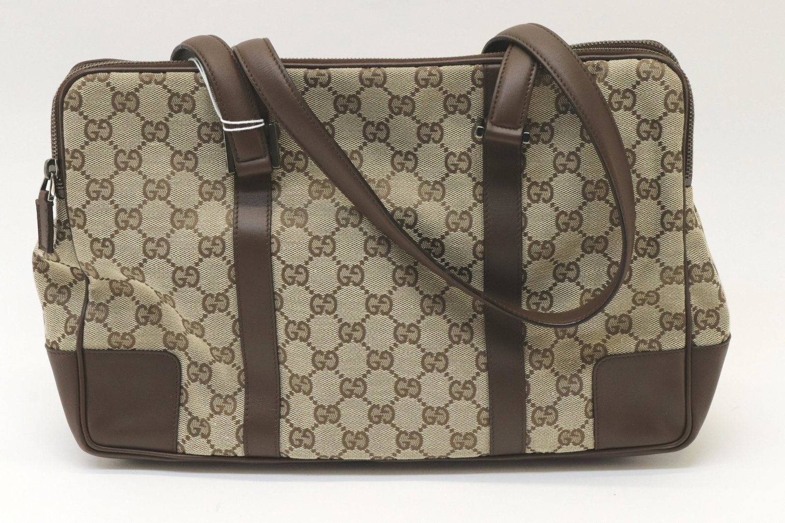 Gucci - Double Zip Tote: Gucci Double Zip Tote, canvas exterior, brown leather in center pocket with magnetic closure, two canvas zip pockets. Serial number 000/0849/2584 Dimensions: 34x22x10cm