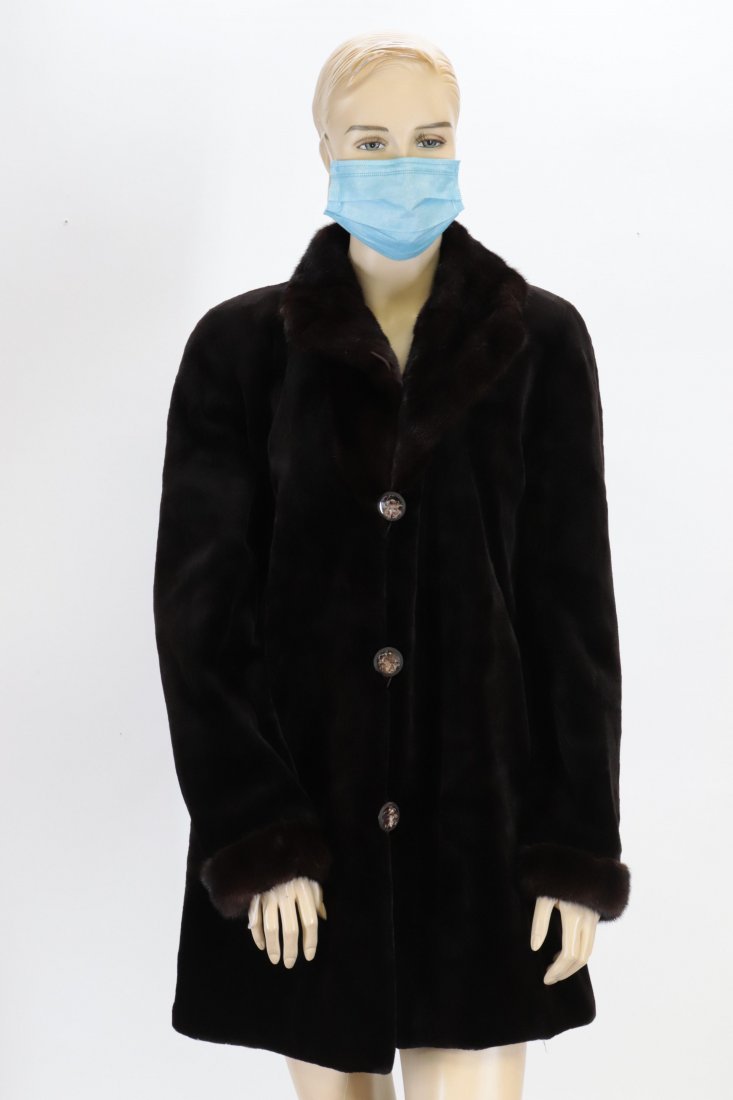 Brown Sheared Mink Coat with Long Mink Collar: 3/4 legnth sheared mink coat with long mink collar and sleeve caps. Brown taffeta lining. 3 button front closure; front slip pockets, interior slip pockets. 18.5" underarm to sleeve end, 22" underarm