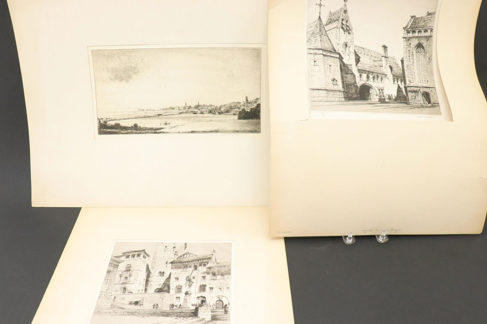 Three Etchings: S.Chamberlain; W.D. Macleod: (2) Samuel Chamberlain (American 1895-1975): "Ho(s)pital St. Jean, Bruges, edition 80/100 and "Plaza St. Martin-Segovia", edition 56/100. (1) W. Douglas Macleod (British 1892-1963): "1922 Ballantrae".