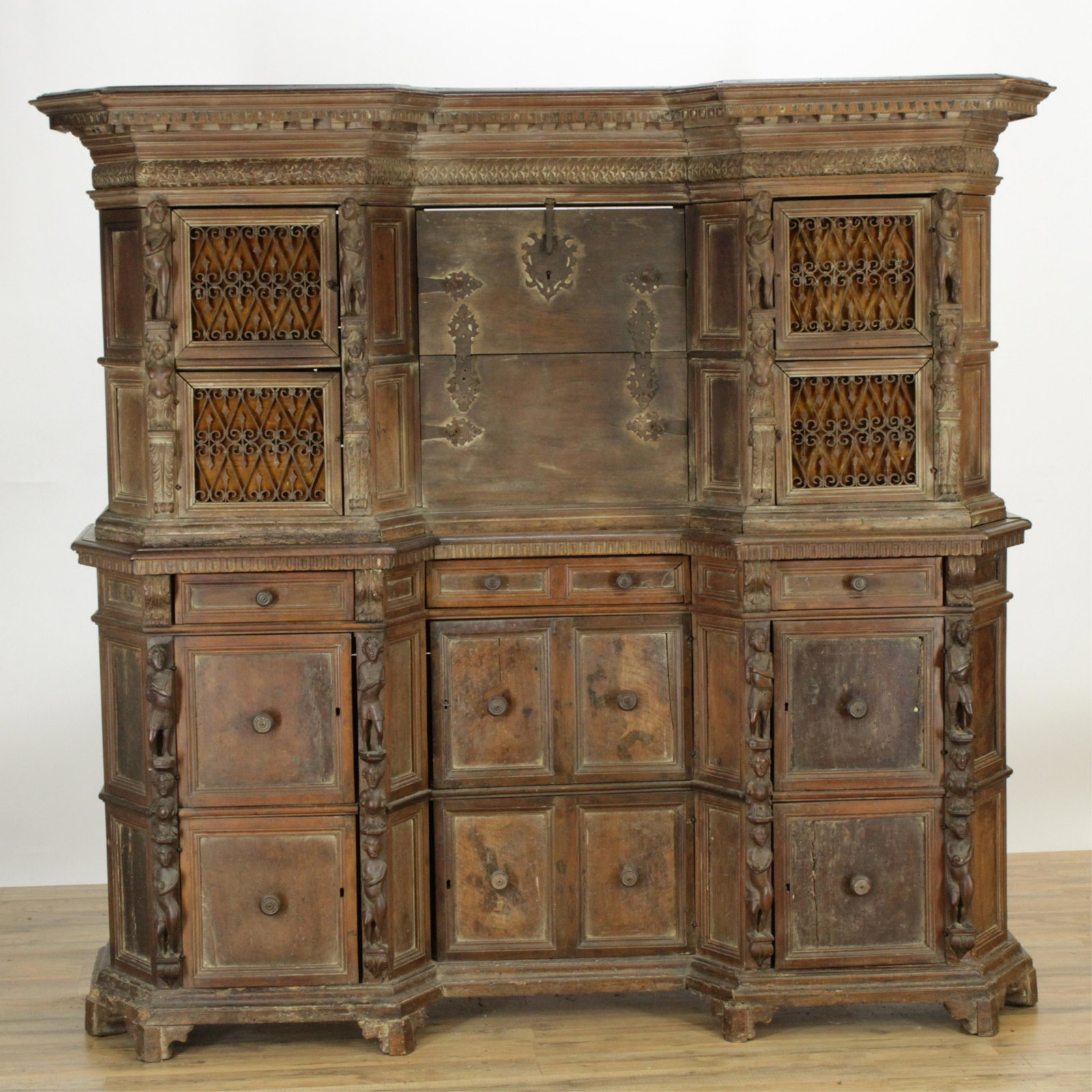 Italian Baroque 2-Part Cabinet on Cabinet: Italian Baroque 2-Part Cabinet on Cabinet, walnut and wrought iron grill work, figural mounts, fall front central section (RIJO2670)(WT) Dimensions: 62" H x 64 1/2" W x 16" D Property From the Estate 