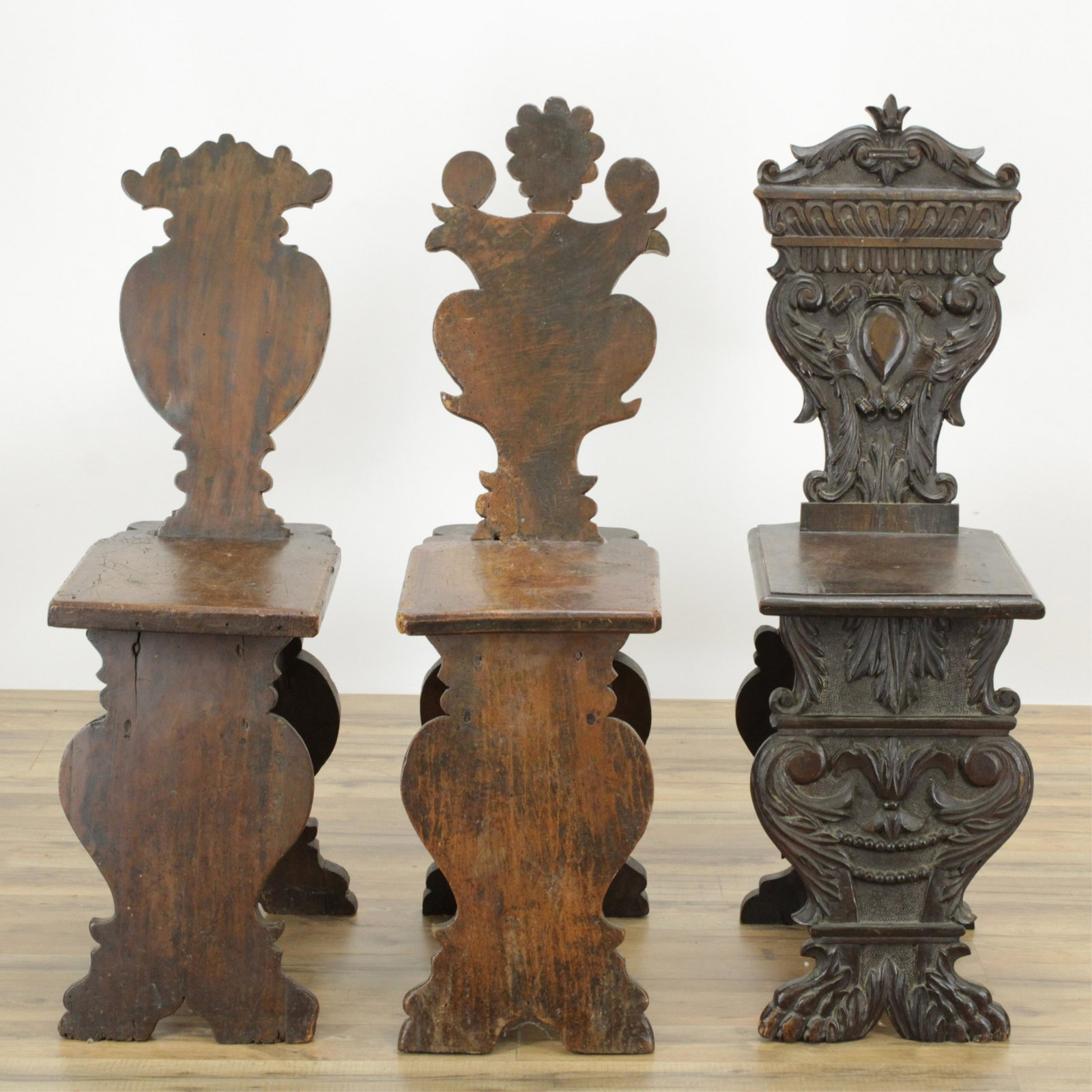 3 North Italian Baroque Hall Chairs: 3 North Italian Baroque Hall Chairs, walnut, two elaborately carved, the other plain (RIJO2381/3)(WT) Dimensions: 39 1/2" H x 12 1/2" W and 37 1/2" H x 11 1/2" W Property From the Estate of Richard I 
