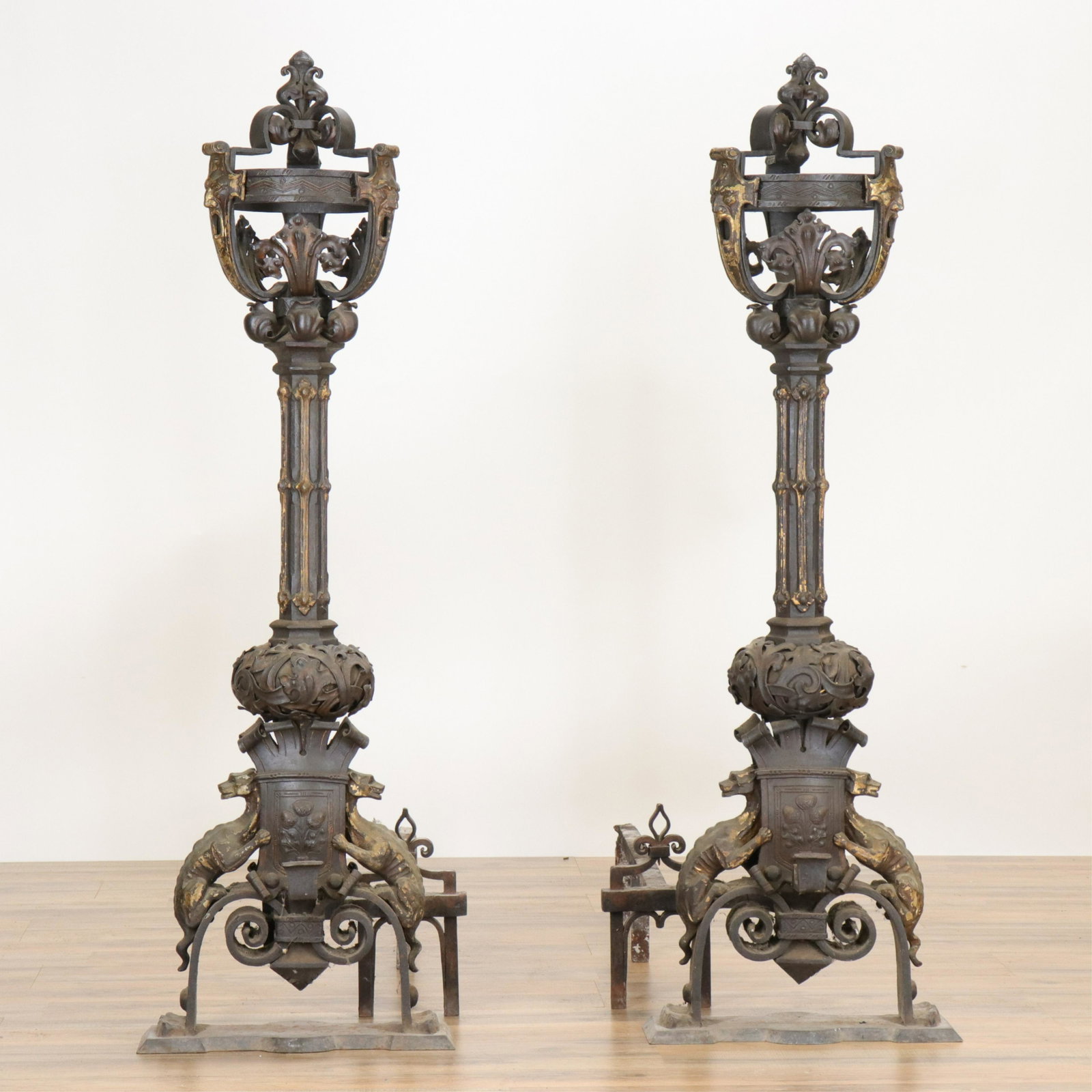 Pair Renaissance Revival Wrought Iron Andirons: Pair Renaissance Revival Wrought Iron Andirons, parcel gilt devil masks and dragon (RIJO2497/2)(WT) Dimensions: 47 1/2" x 15" W Property From the Estate of Richard I Johnson (1925-2020), Chestnut Hill