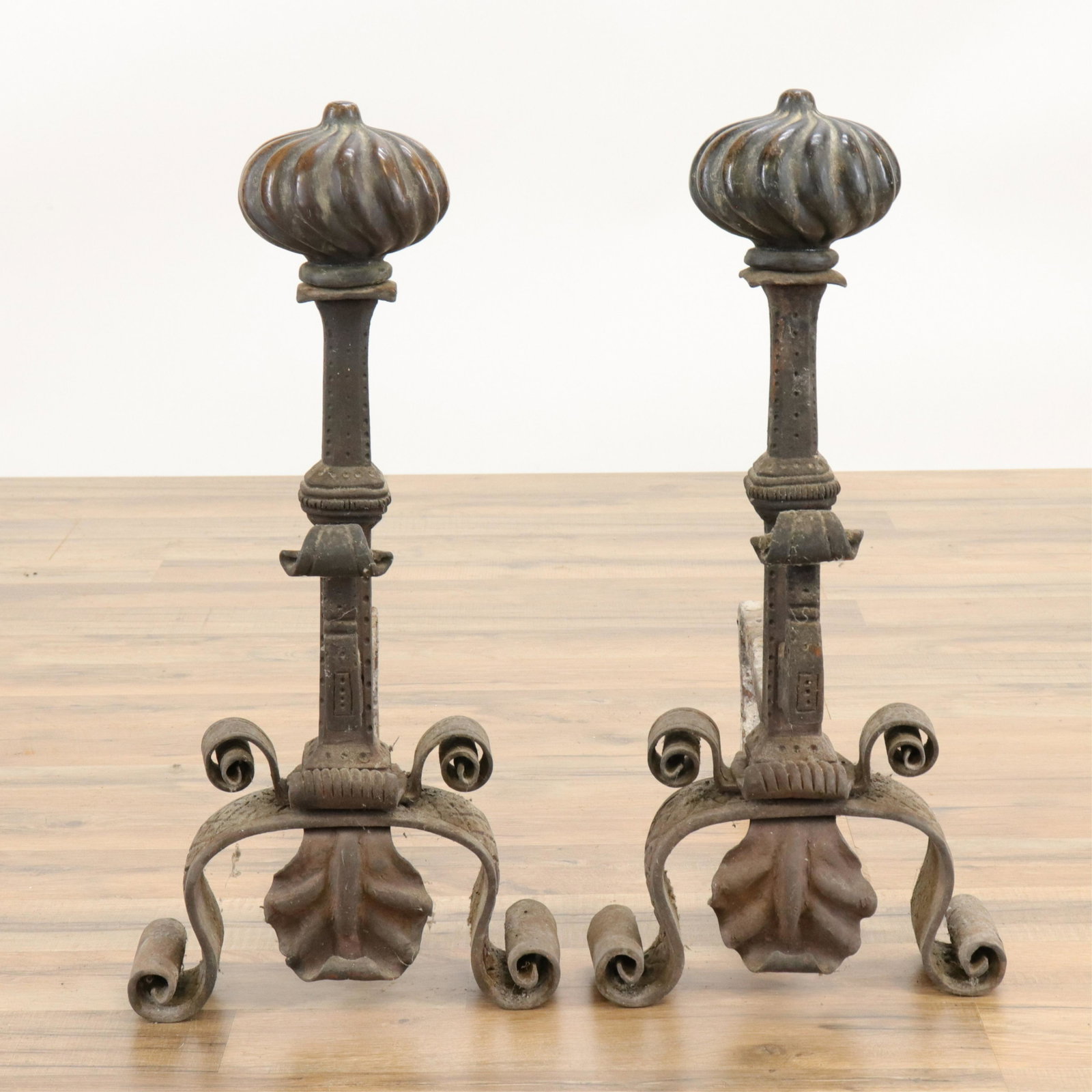 Pair Spanish Style Bronze & Wrought Iron Andirons: Pair Spanish Style Bronze & Wrought Iron Andirons, twist turned tops, plus fire tool. (RIJO2499/3)(WT) Dimensions: 21" H x 10" W x 21" D Property From the Estate of Richard I Johnson (1925-2020), Ches