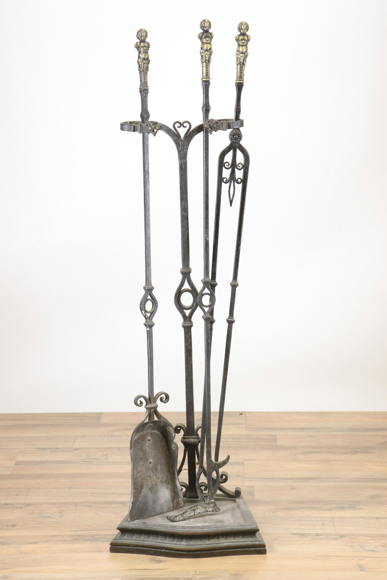 3 Renaissance Revival Wrought Iron Tools, Stand: Set of 3 Renaissance Revival Wrought Iron Tools & Stand, gilt figural handles, lion head to stand (RIJO2498/4)(WT) Dimensions: Tools 45 1/2" H Property From the Estate of Richard I Johnson (1925-2020)