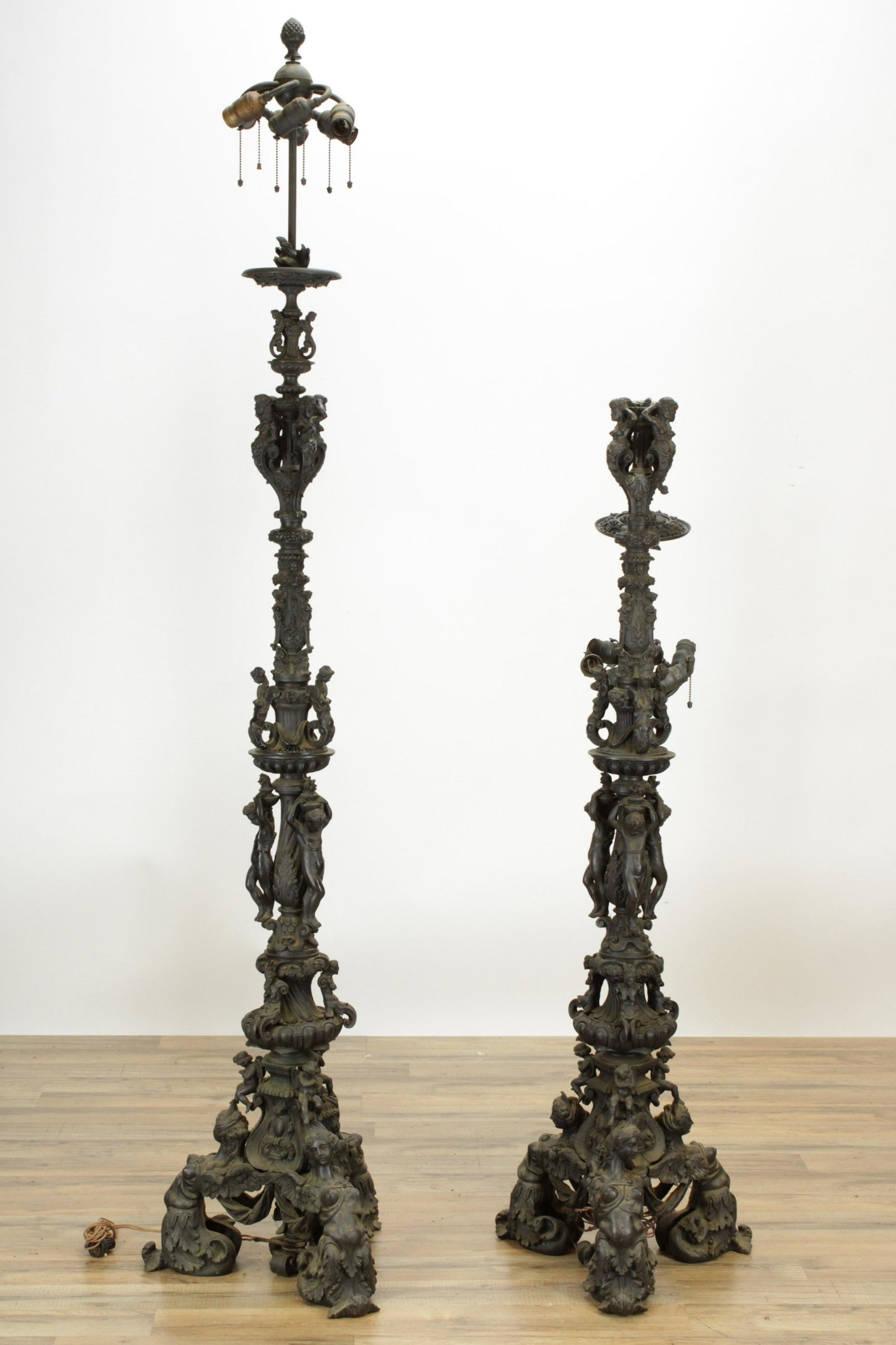 Renaissance Revival Bronze Torchere Lamps, c1880: Pair Renaissance Revival Bronze Torcheres, circa 1880, now electrified, extensively worked with mythical female figures and youths, vellum illuminated manuscript page shades (RIJO2685)(WT) Dimensions: