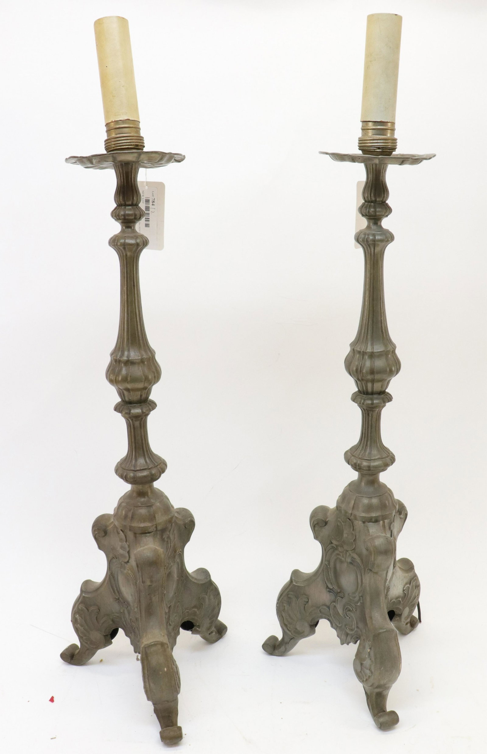 Pair of Baroque Style Repousse Candlesticks: Pair of Baroque Style Repousse Candlesticks, fitted for electricity (RIJO784/2)(MS) Dimensions: 24" H x to the fixture Property From the Estate of Richard I Johnson (1925-2020), Chestnut Hill, Massach