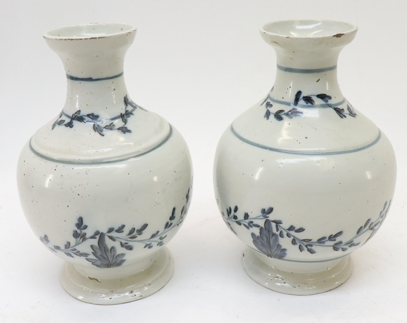 Pair of 18th C Franco Flemish Vases: Pair of 18th C. Franco Flemish Vases, off white ground with blue painted foliate garlands (SOSC2396/2)(MM) Dimensions: 8"H x 6"W From a Hartford County Connecticut Home