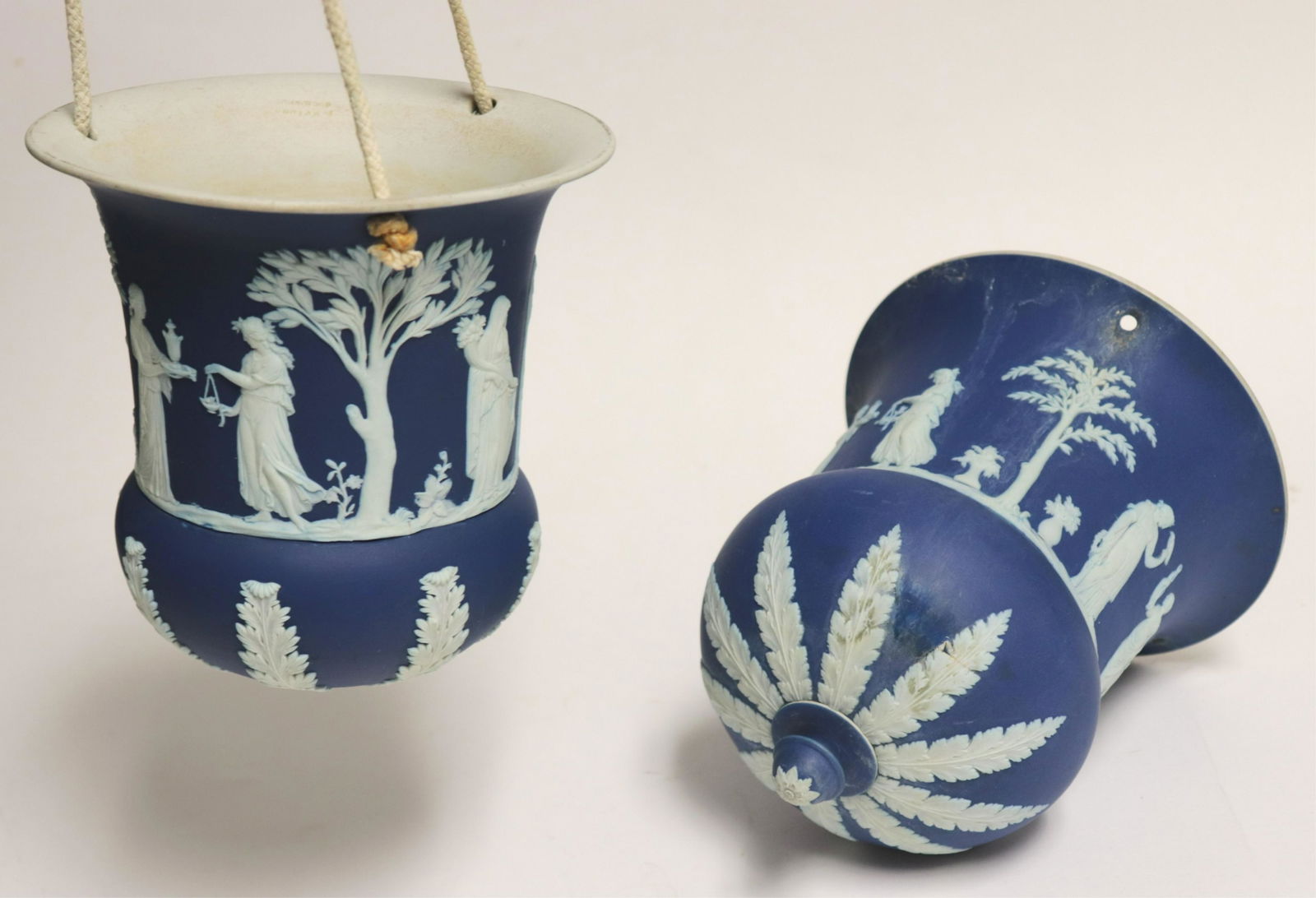 Near Pair Wedgwood Dark Blue Jasper Dip Planters: Near Pair Wedgwood Dark Blue Jasper Dip Hanging Planters, trees and figures, one with impressed mark and Made in England, the other only with impressed mark (2 pc.) NOTE: This lot is being reoffered d
