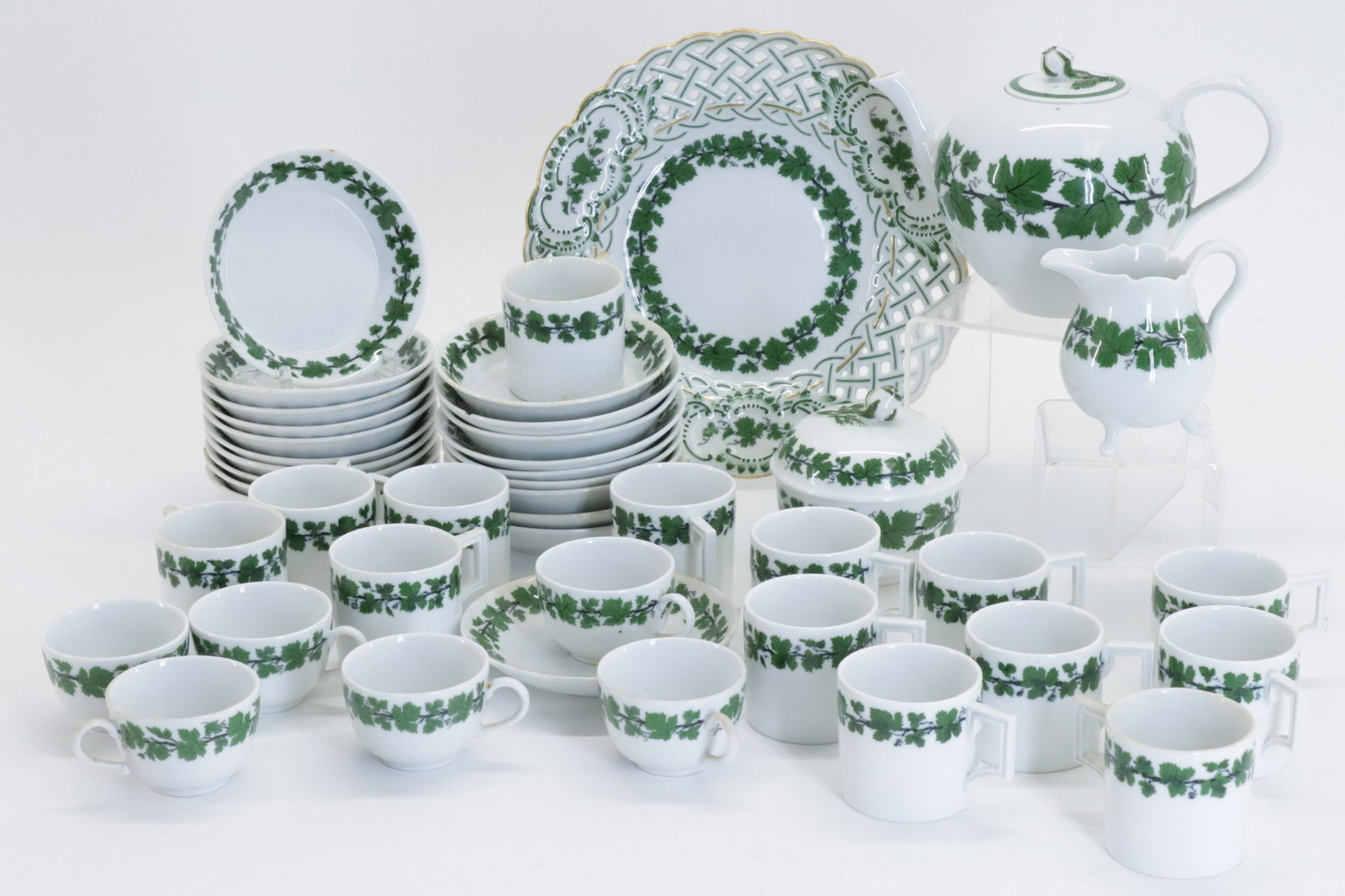 Partial Meissen Green Vine Pattern Porcelains: includes demi tasse cups and saucers, reticulated plate, teapot, sugar and creamer (BSTN139)(MM) Dimensions: 2 x 3, plate 8 3/4" diameter Property from a Canton Connecticut home, many furnishings desc