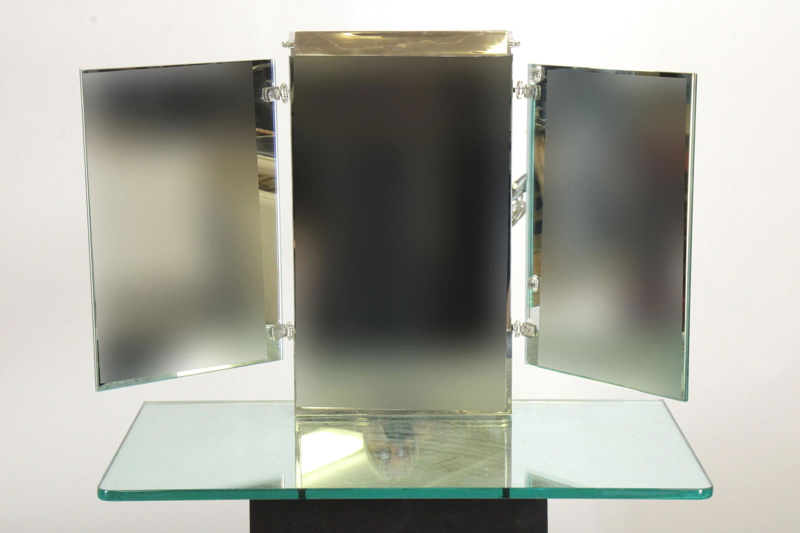 Miroir-Brot Vanity Mirror: Art deco triptych illuminated vanity mirror on base by Miroir-Brot, France. Attributed to Jacques Adnet. (NJWA134)(MS) Dimensions: 24" H x 31" W x 17 1/2" D Property from the Estate of an Important Ne