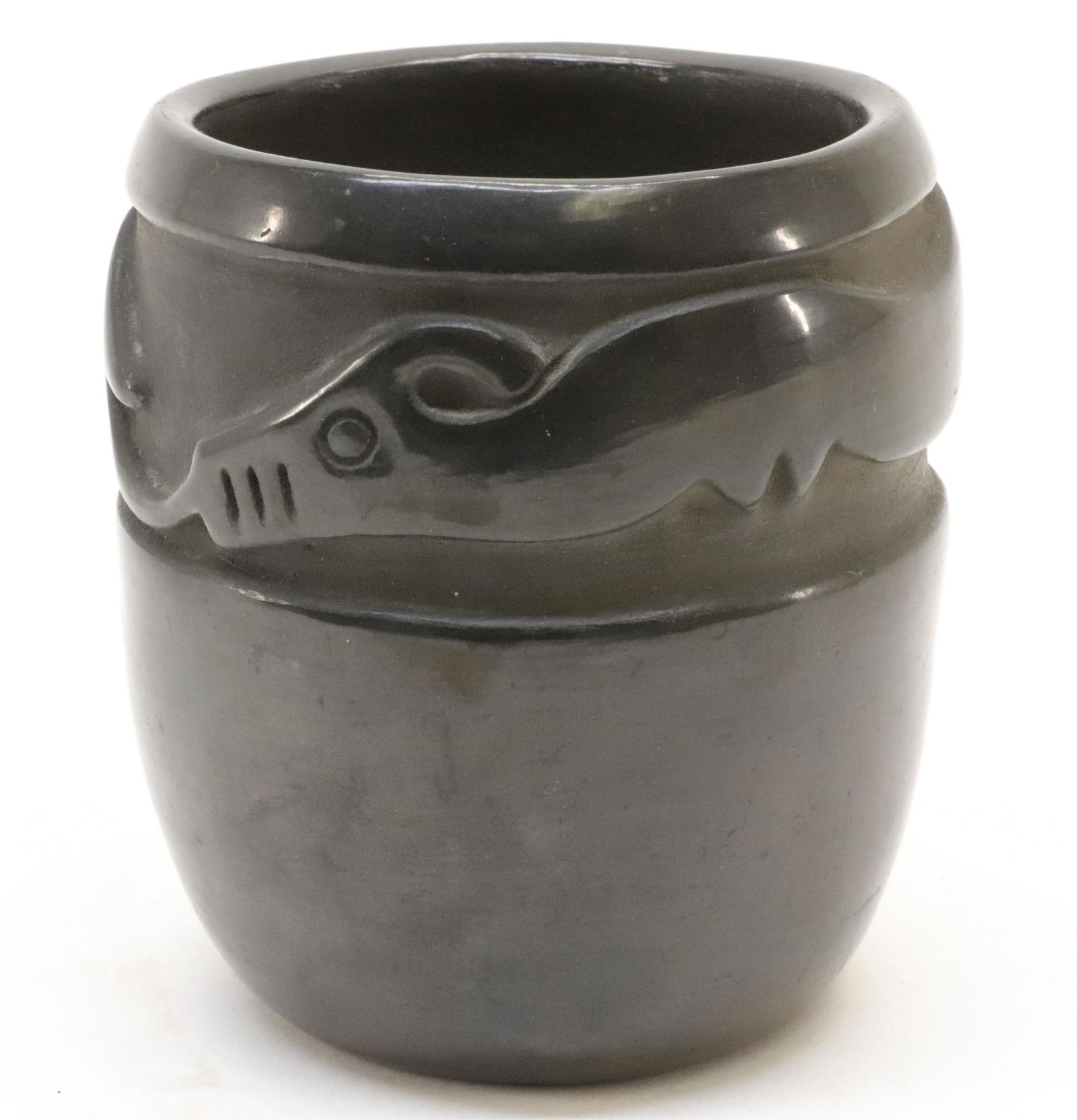 Blackware Pottery Jar, San Ildefonso Pueblo NM: As jar, bowl, or vase. Deeply carved arrow tongued serpent band along top. Signed on bottom Flecista Wo-Leen. Paper note included found in jarDimensions: 4.5" dia. x 5H (BAIL165)(JP)