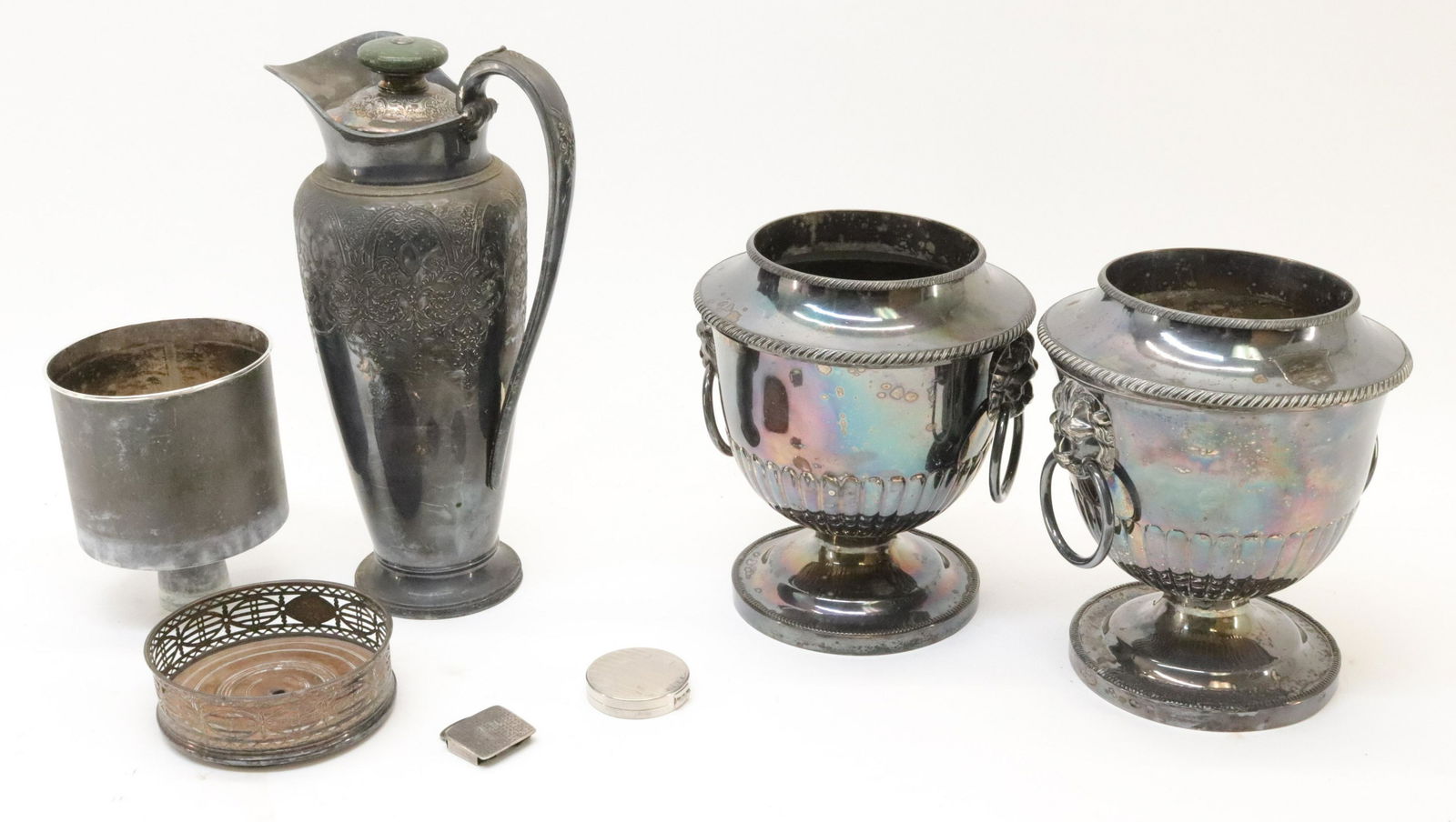 Six Silverplate: Pair Wine Cooler Urns; Pitcher: Pair bail handle urns, removable inserts. Wilcox "Paisley" tall pitcher, cork fitted stopper lid. Wine/bottle coaster. Richard Hudnut compact. Belt buckle.Dimensions: Pair: 8.75"H x 7.5 dia. Pitcher 1