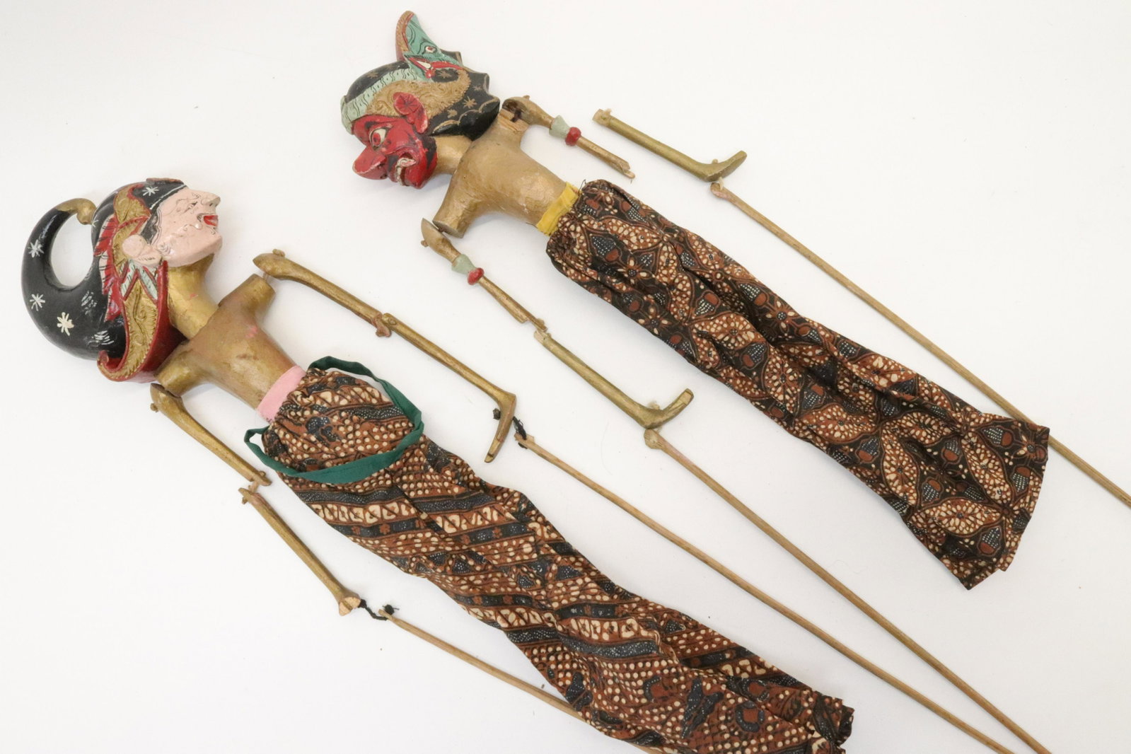 Two Wayang golek Sudanese Puppets: Two Wayang golek Sudanese Puppets. Two carved wooden and well painted puppets. One of the red-faced Cepot and the other possibly depicting Wisnu. 20th century. Dimensions: 20" tallest