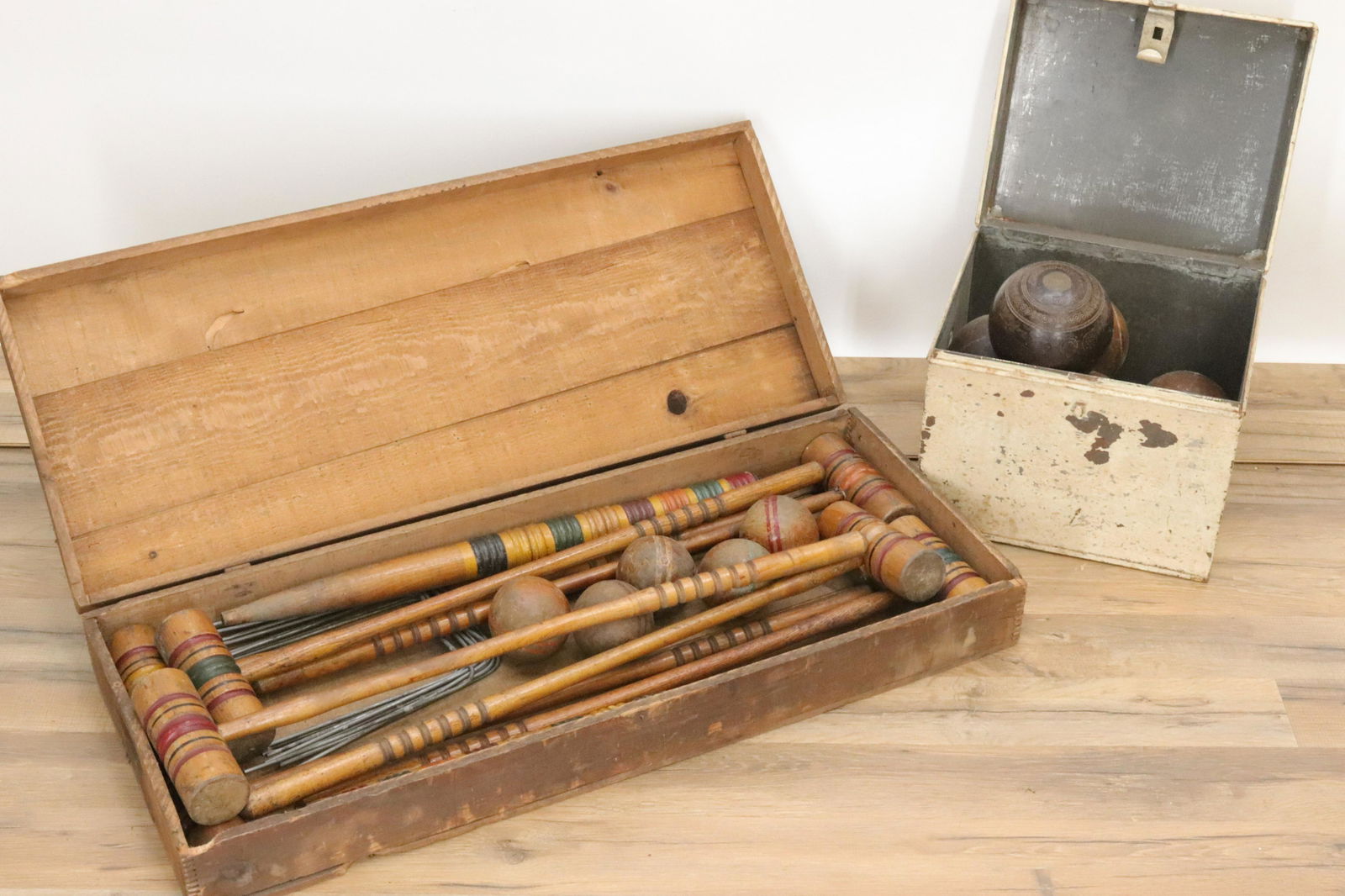 Vintage Lawn Games Sets: Croquet, Bocce/Lawn Bowl: Croquet set: (7) mallets, (5) balls, (2) stakes (9)metal wickets. Polychrome paint. In old wood storage box. (8) Bocce/lawn bowling set and a Taylor-Rolph Co. London signed ball, in painted metal porc