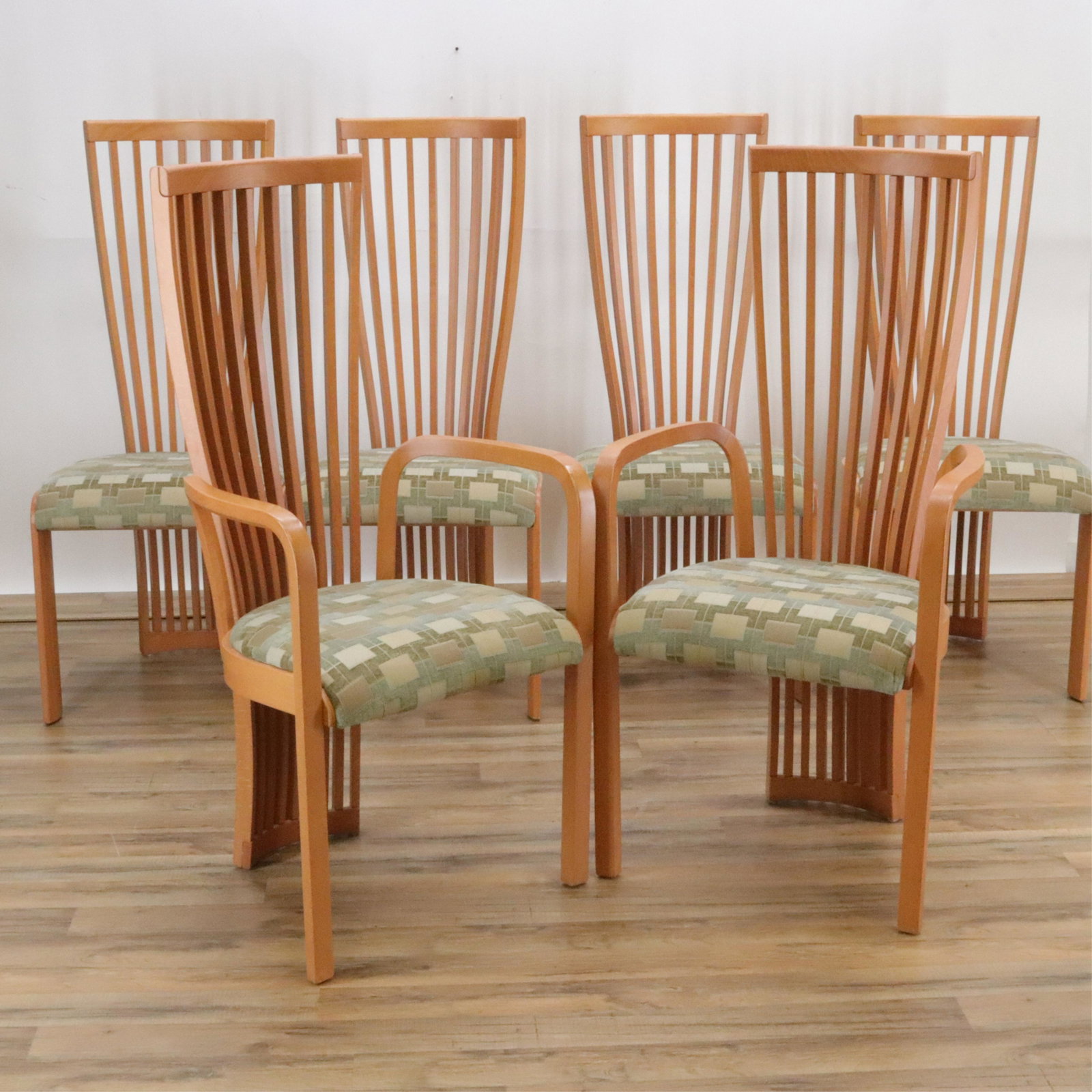 Six Tonon (Italy) Dining Chairs: Continuous spindle back to floor. Honey-maple satin finish. Upholstered seats with geometric pattern muted fabric. Inside of front legs with beveled shape. Very solid construction. Dimensions: Side ch