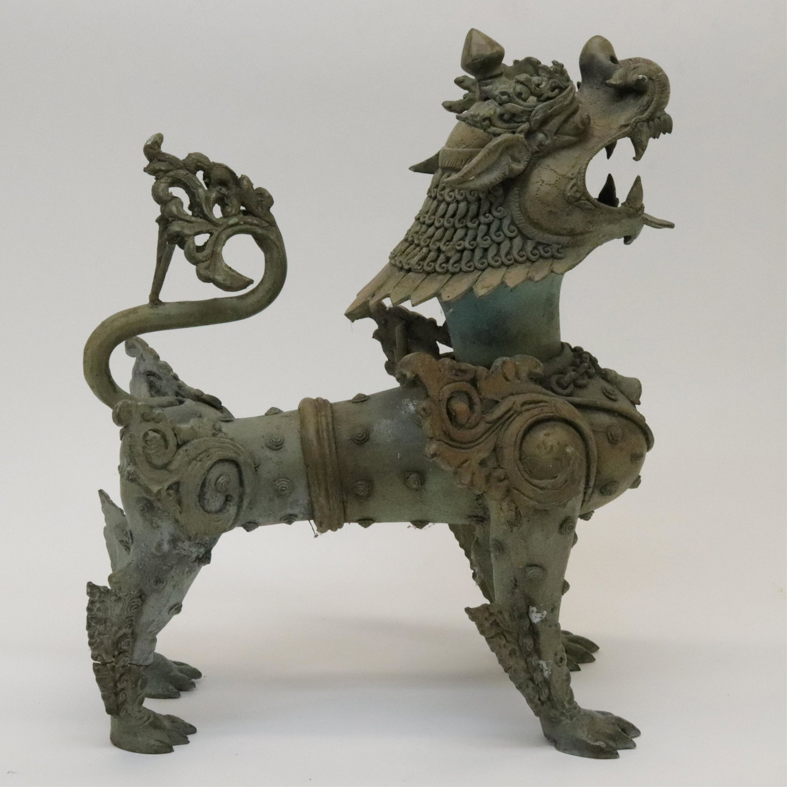 Thai Bronze Buddhist Lion: Thai Bronze Buddhist Lion, Early 20th century. Cast with good detail and with an attractive verdigris patina. Dimensions::16" high Property from a private Alpine, New Jersey collection